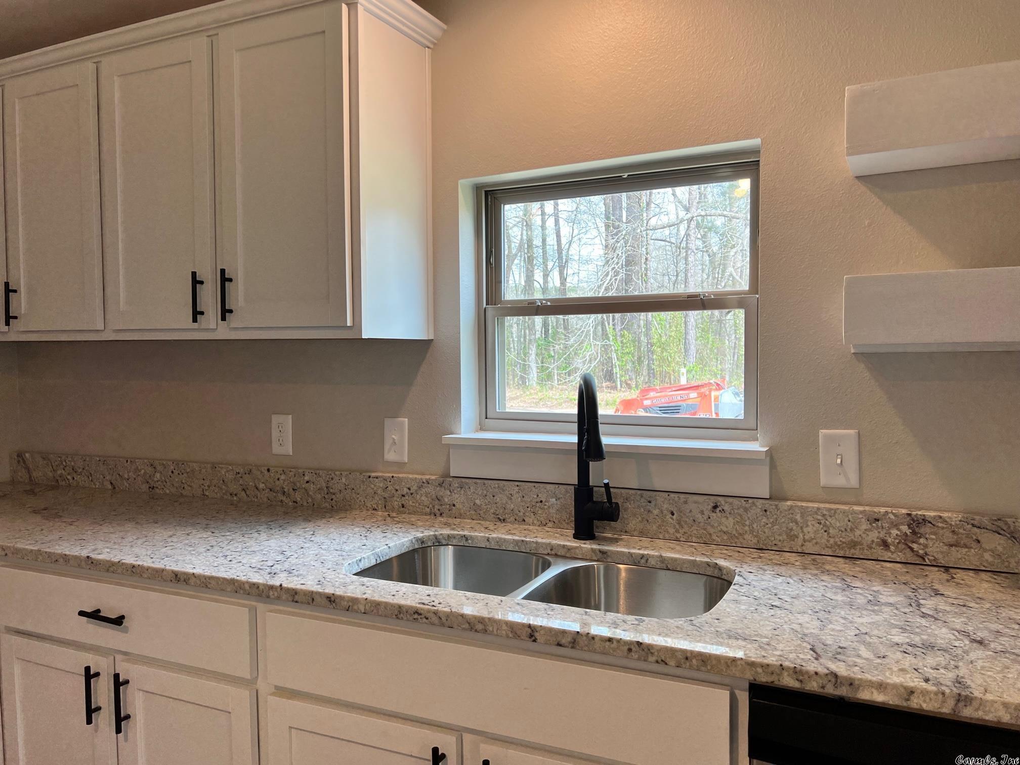 This Lake Hamilton Area Home is a combination of a Manufactured Home (built in 1985) and a Large Stick-Built Addition + Detached Garage. It has been Completely Remodeled to include: EVERYTHING! Roof, Windows, Electrical, Plumbing, HVAC... as well as the ENTIRE Interior: Walls, Flooring, Kitchen, Bathrooms, Lighting & Plumbing. It lives NEW! Split Floor Plan. 2 Living Areas! Situated on .86 Acres, you will love the Large Yard & Neighborhood Park w/ Lake Access to Lake Hamilton! Darling & Affordable!