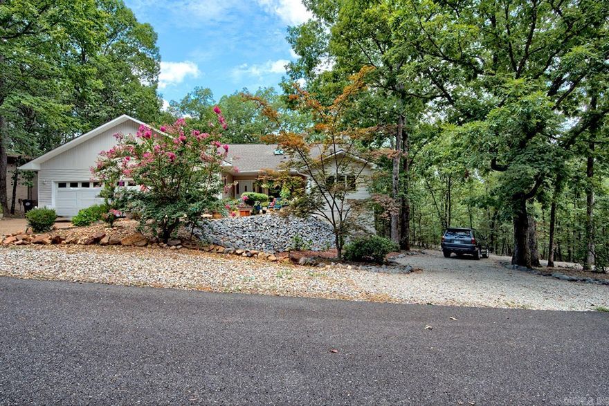 Surrounded by nature in a peaceful, quiet neighborhood yet just minutes from beautiful Lake DeSoto, Waypoint Cafe & Marina, hiking trails, and many other amenities. This one-of-a-kind 5 bedroom 4 and a half bath charming home is perfect as a multi-generational residence, an investment property, or for entertaining guests. The upper level features bright skylights, cozy gas fireplace, a gourmet kitchen, vaulted ceiling, sunroom, 3 bedrooms, and 2 and a half baths. The spacious primary suite with access to the deck boasts a large closet,ensuite bath with his & her walk-in closets, jetted step-in tub, step-in shower, and water closet. THE LOWER LEVEL consists of 2 fully furnished income-producing properties: a one-bedroom apartment and a studio apartment. The apartments have private entrances and a separate parking area. Nestled among the trees in the nation's largest gated community is this inviting gem.  Make it yours today! (Be sure to View the virtual tour.)