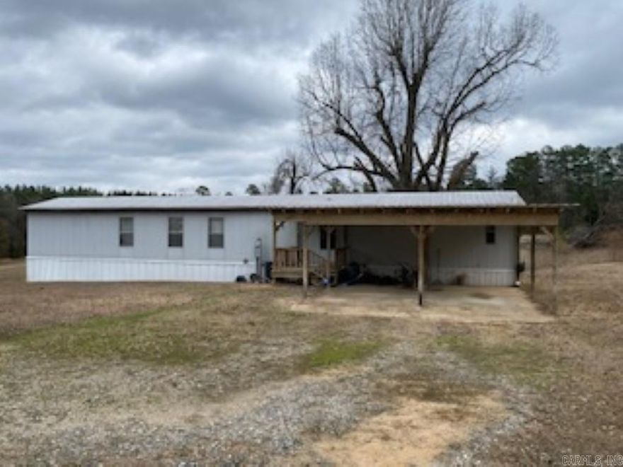 Looking for a Country retreat!? Sit back and relax, enjoy that perfect evening! Call it a day. Sitting on 11.54 acres this 3-bedroom 2 bath mobile home is ready for its new owners, a 2-car carport on front, and a deck off the back, and a storm shelter in the side yard. The additional acreage has a beautiful building spot on the hill and electric and septic is already there.