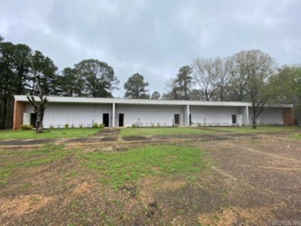 Commercial building with over 8000 sq feet, concrete slab building once known as the Co-Op building. This would make a great meeting building, funeral home, residential apartments, fun center, and so many more options. This property comes with 3.5 acres, so expansion room or parking room is already done. This property is in the city limits has city water, sewer, gas, lights, and central heating and air. Roof has been repaired. Not sure age of building. Property is Agent owned.