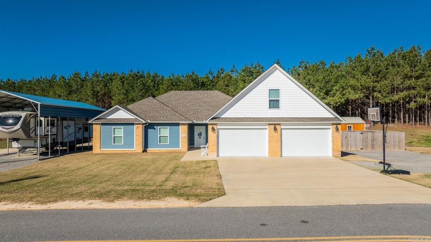 This beautiful 2,240 square foot home is built on 3 open acres of land. The open acreage is perfect for many different outdoor activities. It has a camper carport to go along with it.  The home is a 4 bed, 2 bath beauty.  The upstairs bedroom is perfect for a bonus room if you would like one. It has great space with a nicely sized closet. The first floor has 3 bedrooms with the primary on the opposite side from the others. There are 2 large closets on opposite sides of the bathroom. The open floor plan and great lighting make the kitchen, dining, and living area seem very spacious. The back porch is covered with room for many amenities.  The back yard has a large gate and is fenced in ideal for dog lovers. The oversized garage has room for 2 vehicles to open their doors on both sides and still have room on the ends and in the back of the garage. Don't miss this. It will go quick!