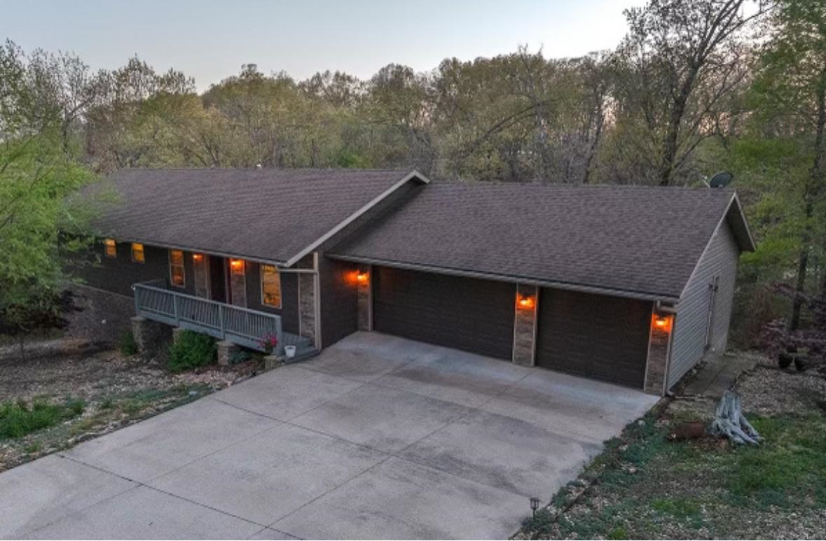 From High up in the Ozarks!!! Opportunity does come knocking !!! First time on market custom home built in a prime location in thriving NW Ar. Just minutes from downtown in Beaver Lake area with close access for boating, fishing, kayaking as well as on your way to gorgeous Hobbs State Park offering numerous hiking trails, outdoor activities at their best. This better than new home is in a wonderful area of custom homes with private park like settings through out, Can you say PRIDE of ownership? Here it is!!! You will love living at the end of the Cul De Sac allowing for a quiet peaceful street and YES, less traffic!!! Enjoy your outside living spaces, a large open deck, with a perfect size screened porch for rainy nights outside! Come inside to the open floor plan, custom hickory cabinets, granite tops, gas fireplace, all taking full advantage of your private woods! Spilt BR plan, private primary suite and bath, walk in shower with access to the screen porch for your early morning coffee and nature! the Guest rooms are set up nicely and convenient to the 2nd bath. The large garage is set up for 2 cars, a boat, golf cart, or extra storage, Call today, your Ozark adventure awaits!