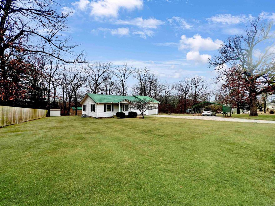 Great well-maintained home with park-like unrestricted property. This 4-bedroom home is conveniently close to shopping, the hospital, schools and businesses, just outside city limits on 1 unrestricted acre. Plenty of storage, great kitchen layout and ready to move in! Fantastic screened-in back deck to watch the wildlife and an open deck to barbecue. Flowers throughout the property and gardens are ready for planting. Two outbuildings for more storage. 2 Car Carport in addition to oversized 1 Car garage. Fiber optic Internet available. Newer metal roof, Regularly serviced HVAC, Privacy fence on two sides only 3 years old. Large Propane Tank. Fourth bedroom is above the garage. Measurements and square footage are approximate.