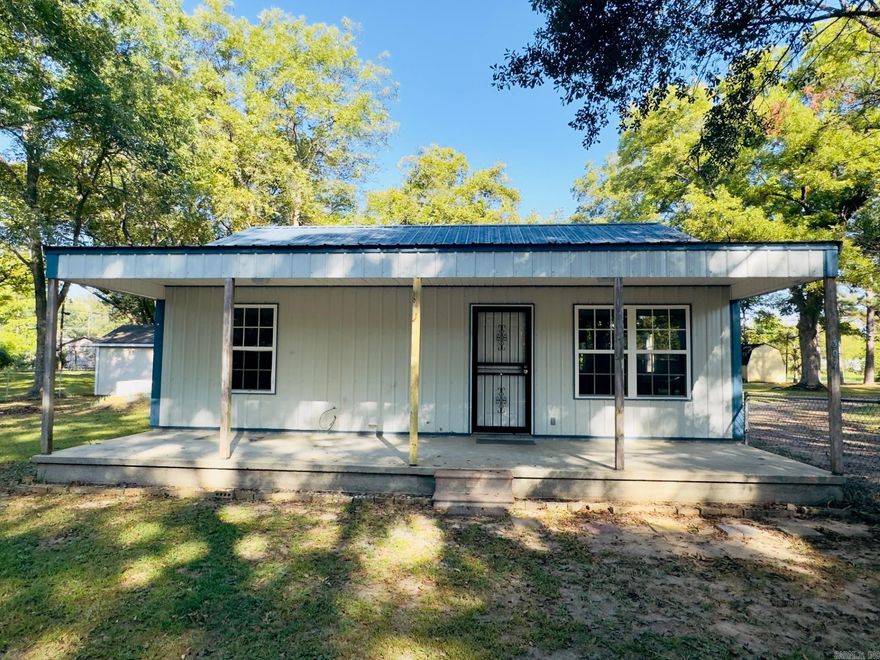 This 2 bedroom, 1 bath home is move-in ready with fresh paint, pretty vinyl flooring and a handy laundry room.  It has a metal roof and siding for easy upkeep.  Outside, you will love the large shaded lot with mature pecan trees, a large shed, and a storm shelter.  The pull-through driveway makes parking a breeze, and the lot is appx. 300 feet wide.  Agents see remarks before showing