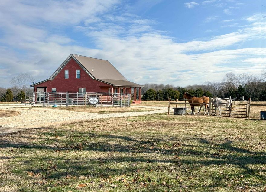 This stunning 2576 sq ft brick home nestled on 20 acres of pastureland offers the perfect blend of rustic country living and modern comfort. The interior boasts a captivating Great Room with custom vaulted knotty pine ceilings and walls, large windows flooding the space with natural light, and impeccable wooden peg construction. The master suite is a true retreat, featuring a spacious bathroom with a walk-in shower and a relaxing soaking tub. Upstairs, discover a versatile loft bedroom ideal for an office or guest room, along with another enclosed bedroom and full bath. Horse lovers will adore the property's amenities, including a riding arena, a red iron barn, a bunkhouse, and workshop. Enjoy the peace and tranquility of country living while still being within reach of modern conveniences.