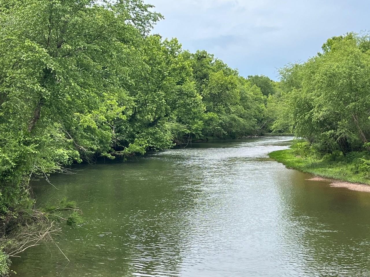 Lot 8 in Caddo Paddock Subdivision has deeded river frontage on the Caddo River. Paved county road access along Old Military Road, municipal water, permitted septic, underground electricity, fiber internet, and deed restrictions serve to protect value as well as enjoyment of the property. Restaurants, float outfitters, and I-30 are less than 1 mile away with Arkadelphia being only 5 miles south. The property has a unique history and is ideal for short term rental investment.