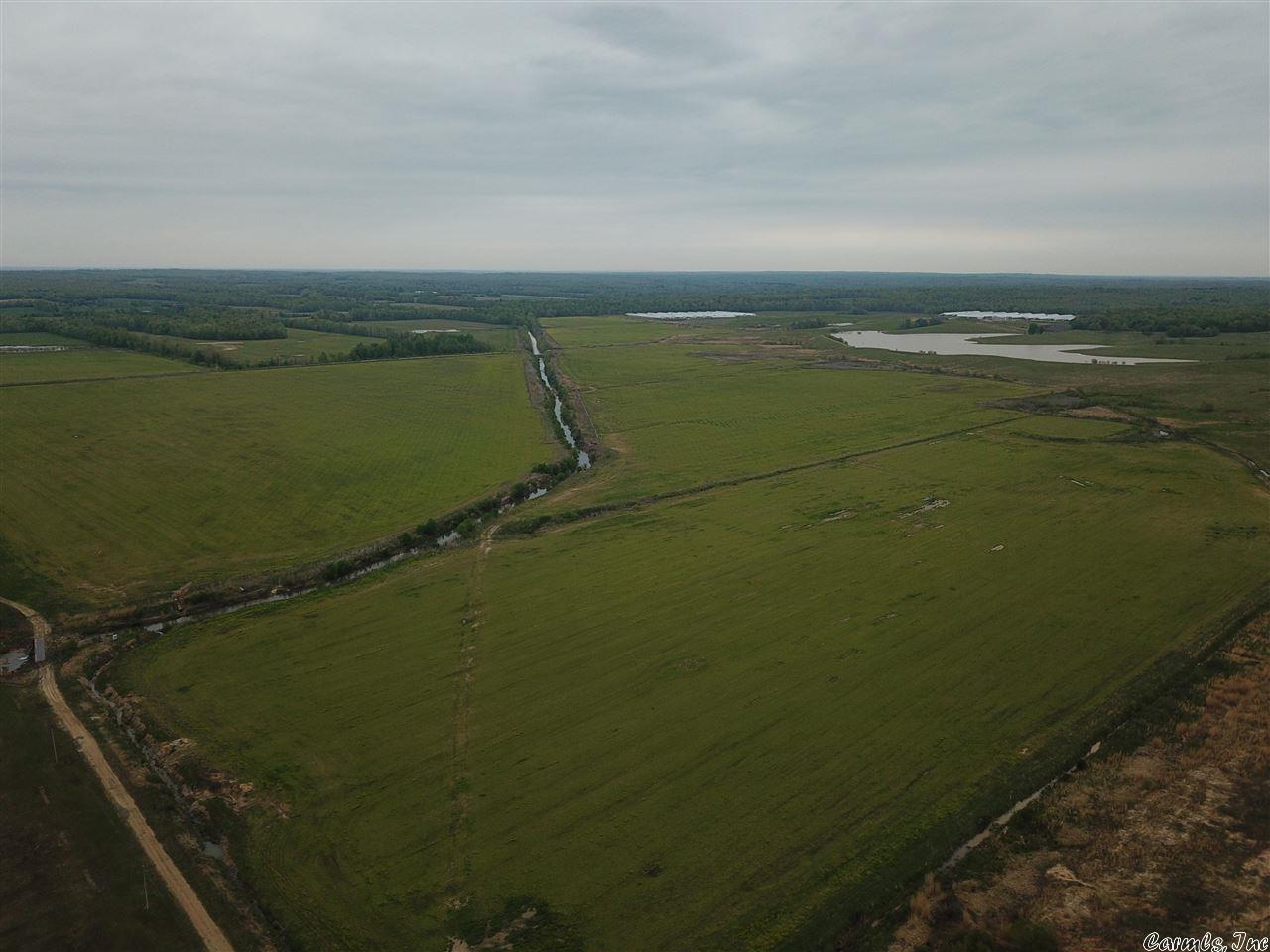 570 +/- acres of Big Creek bottomlands. Over 400 acres of tillable land with 130+/- acres of sprigged bermuda. Two weirs in big creek along with water rights to a 40 acre reservoir provide ample water to irrigate using 4 center pivots along with 5 risers all connected through under ground pipe. There is also a 40x100 shop enclosed on 3 sides, 3 grain bins for storage, as well as a pad site made with dirt pans that were originally made to build chicken houses but could be used for any new infrastructure.