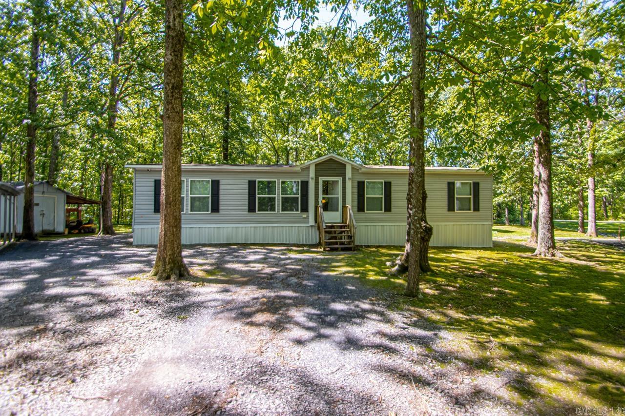 This beautiful property is very private with lots of trees and room to roam. If you are looking for privacy do not look any further. Well maintained 3 bedroom 2 bath home. Split bedroom plan. The kitchen, dining and living room are partially open to each other. The kitchen has a large island and plenty of room to move around. The pantry is HUGE!!! Great laundry room area. The primary suite is large with a great primary bathroom. The bathroom connects to the laundry room for easy distribution of laundry. The covered back porch is awesome. You will be drinking your coffee and watching all the deer. Enjoy your very own SHOP with lean to. 18x21 shop with 11x21 lean to. This is currently used as a one car carpot. Nice driveway entrance off two roads. Call today to schedule your showing on this prime property. See Remarks