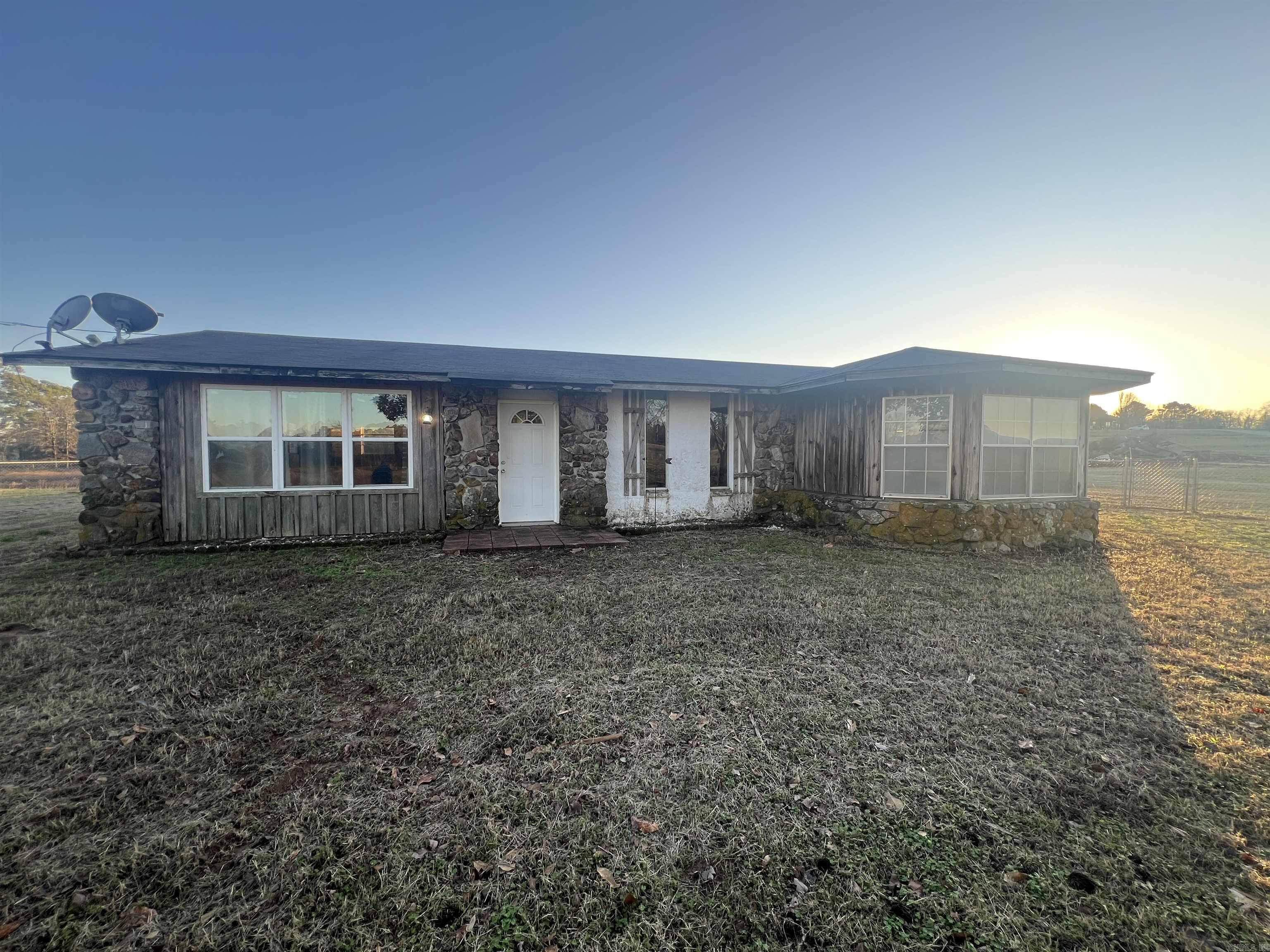 Country home sitting on 3+ acres in Bismarck/New Deroche area. The house is being sold "as is" and is in need a little TLC, but the bones are good, and the potential is endless. It has 2 Bedrooms, 2 Full baths, walk in shower, laundry room and open floor plan makes. The concrete blocks used for exterior are filled with insulation. Plenty of room for horses, a barn and the family farm you always wanted. See agent remarks.