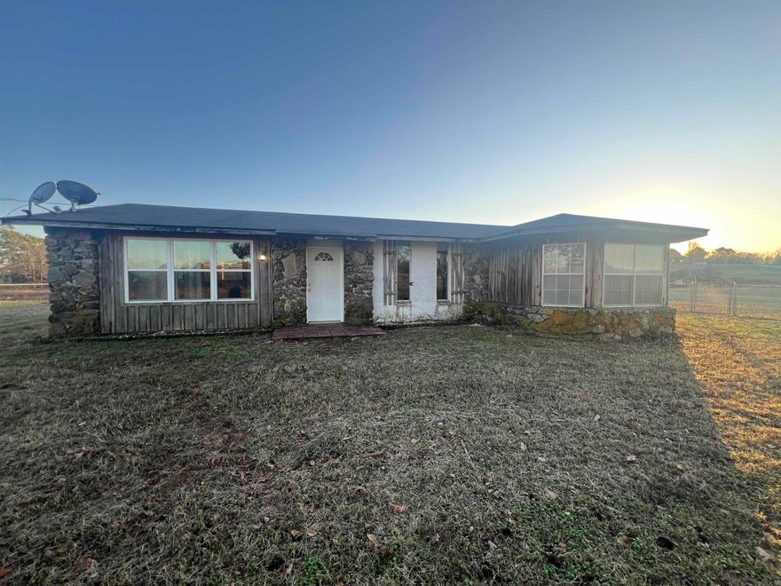 Country home sitting on 3+ acres in Bismarck/New Deroche area. The house is being sold "as is" and is in need a little TLC, but the bones are good, and the potential is endless. It has 2 Bedrooms, 2 Full baths, walk in shower, laundry room and open floor plan makes. The concrete blocks used for exterior are filled with insulation.  Plenty of room for horses, a barn and the family farm you always wanted. See agent remarks.