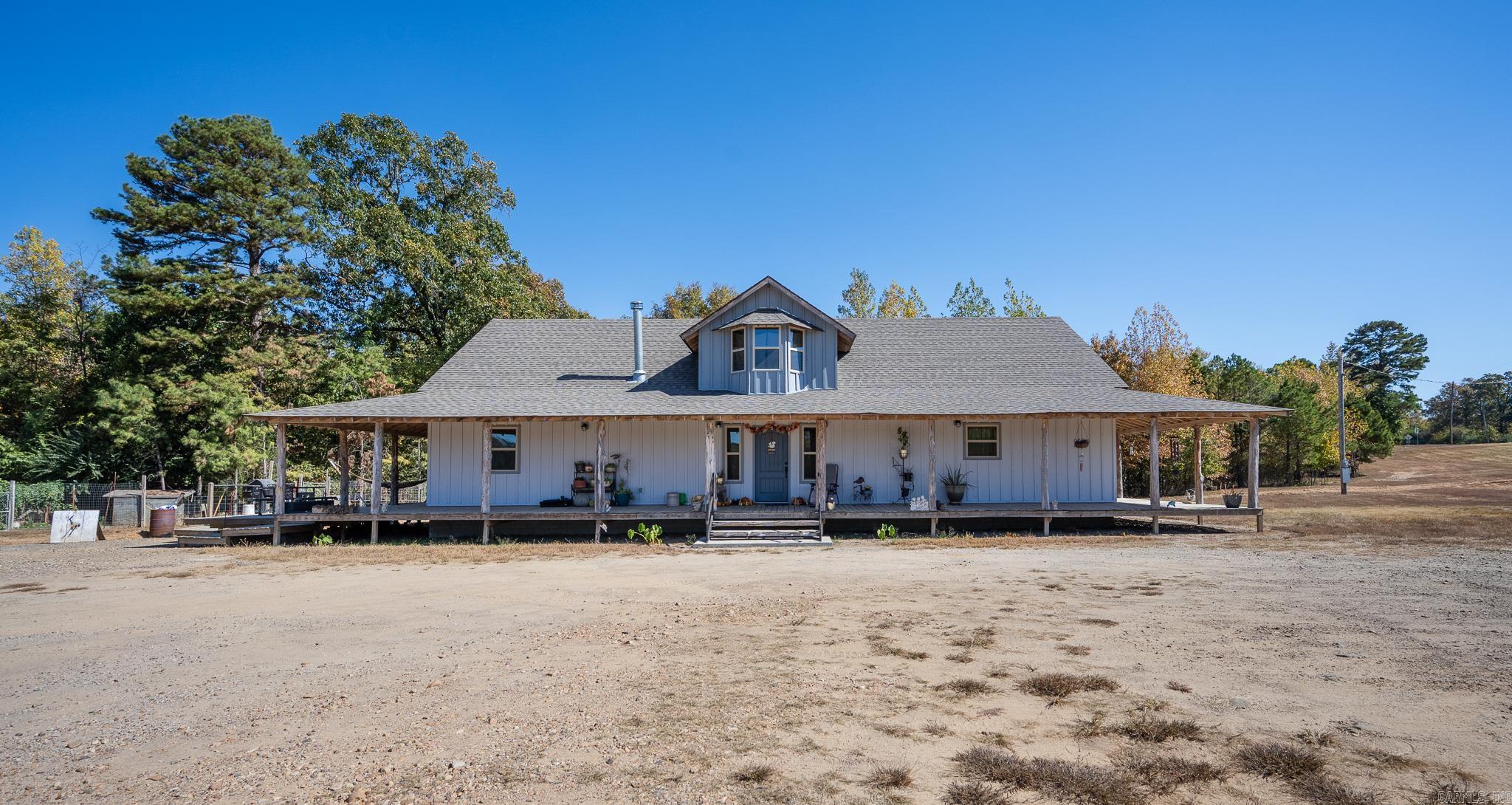 LISTED BELOW APPRAISAL! MOTIVATED SELLER. 3 acres located outside the town of Cove. Featuring this 3200 sq ft 4-bedroom, 3 bath home built in 2022. Granite countertops, beautiful wood floors & ceramic tile throughout. White Oak staircase to second floor. Wood burning stove for backup heat. Amazing wrap around porch with decks, could be great for Saturday morning coffee sipping or enjoying your evening cooking out with family & friends. Vapor barrier & lights installed in crawlspace under home. New 26x24 chicken coop. 12x20 storage building. Two RV hookup combination boxes containing 110, 30 & 50 amps, each having own Water & Sewer. 32'x110' Metal Shop with 16 ft sidewalls, concrete floor & foam insulation from ground to peak. Septic is available to shop. Over 1000' Highway 71 frontage. Great business opportunity!