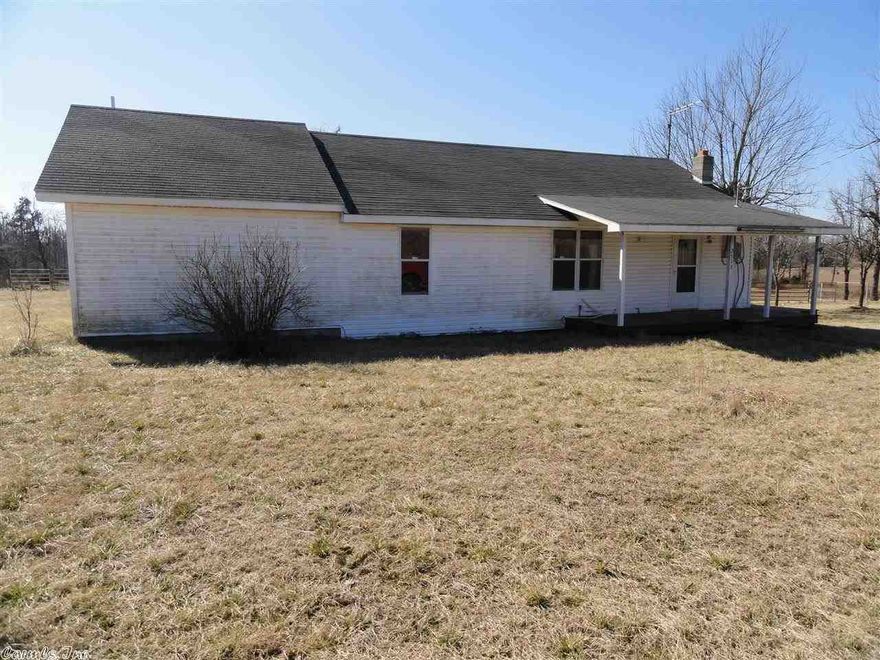 Nice mini-farm with a partially remodeled older home. 2 bedroom now but the master bedroom could be partitioned off to create a third bedroom.Large master bedroom/bath.Large living room.Level land, barn, pond, fenced with horses on property now. Ready for your livestock or horses.Some acreage across the highway.Has rural water,also has well, could be used if repaired.There is also an old hand-dug well just off the back porch that still is full of water.Detached garage/shop building. Chimney for wood stove.