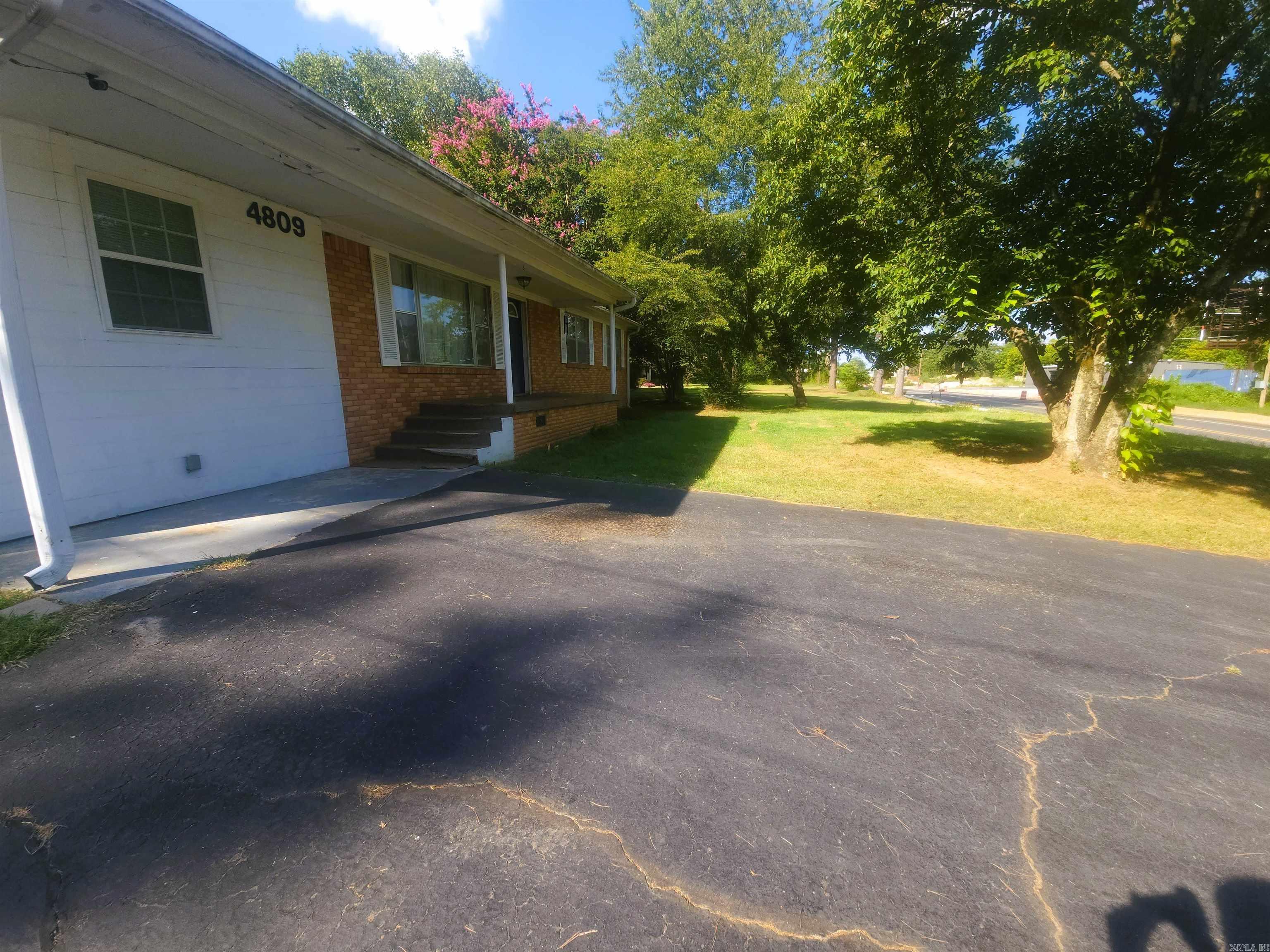 Move-in ready 4BR-2BA brick home near Fountain Lake School. Features hardwood floors, bright living room with fireplace, spacious kitchen, covered back deck, fenced backyard, RV shed, shop/storage building, and concrete driveway with ample parking.