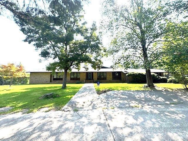 Fall in love with this unique, custom-built home offering 4 bedrooms, 3.5 bathrooms and 4738sf, situated on 3.86 acres. Architecural shingle roof replaced in 2020. 3 HVAC units, gas heat - 1 unit is 2-5 years old, the others age unknown. 2 - 40 gallon water heaters. Hardwood & carpeted flooring. Spacious kitchen with gas range. Enjoy the home's 2 fireplaces; 1 is WBFP, 1 is gas logs. Step down den with access to the beautiful backyard. Possibility for 2 home offices or to use for whatever purposes you need. Green house, large storage building, & "wood shed". Attached is an additional studio for an in-law or college student, offering a full bath with large jetted tub, & area for a kitchenette. ALSO included is a separate MH that could offer additional income potential. This is a beautiful property with wonderful, huge shade trees. Brick and redwood cedar siding. Located within minutes to everything; schools, businesses, hospital, shopping...anything you need. There are too many amenities to list here. This is a must-see! Call today and make an appointment for your personal tour. 24 hour notice is necessary.