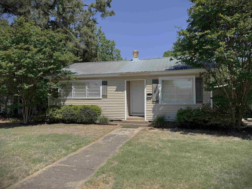 Cozy Home on Forrest Ave E  --  Discover comfort and convenience in this charming 2 bedroom, 1 bath home, close to schools, churches and community amenities.  Perfect as a starter home or a smart investor-friendly property, this home offers practical features and easy living.  A durable metal roof provides long-term peace of mind, while the bathroom includes a tile-surround tub/shower combination for a clean, updated look.  Outside, the property features a concrete driveway and a 2-car portable carport offering ample covered parking plus a beautiful magnolia tree.  With its central location and solid features, this home is an excellent opportunity for homeowners and investors alike.  Don't miss your chance to make it yours! Washer, dryer, refrigerator, microwave and screen will remain.