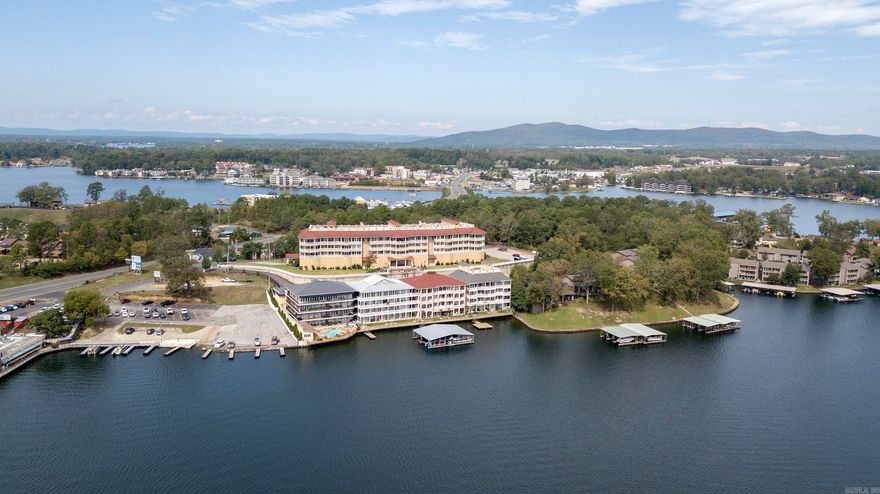 Inviting and Elegant Describe this Fiesta Bay 2 Bedroom, 2 Bath Condo in the Popular 7S Area! Situated on the Main Channel of Lake Hamilton, the Southern View is Exceptional! Walk a few steps from your tandem 2 car covered parking space and enter a luxurious home! The crown moulding on the coffered ceilings and throughout the public spaces will amaze you! Master bedroom features large walk in closets, luxurious master bath with walk-in shower. Gorgeous fireplace and kitchen! Kitchen has SS appliances and granite counter tops, as does the wet bar. Walk onto your own private balcony and revel in the breath taking views of Lake Hamilton! Outdoors is the common area that features a salt water swimming pool and dining cabana with a full kitchen. No boat slip, but there is a swim dock next to the salt water pool. Come see!