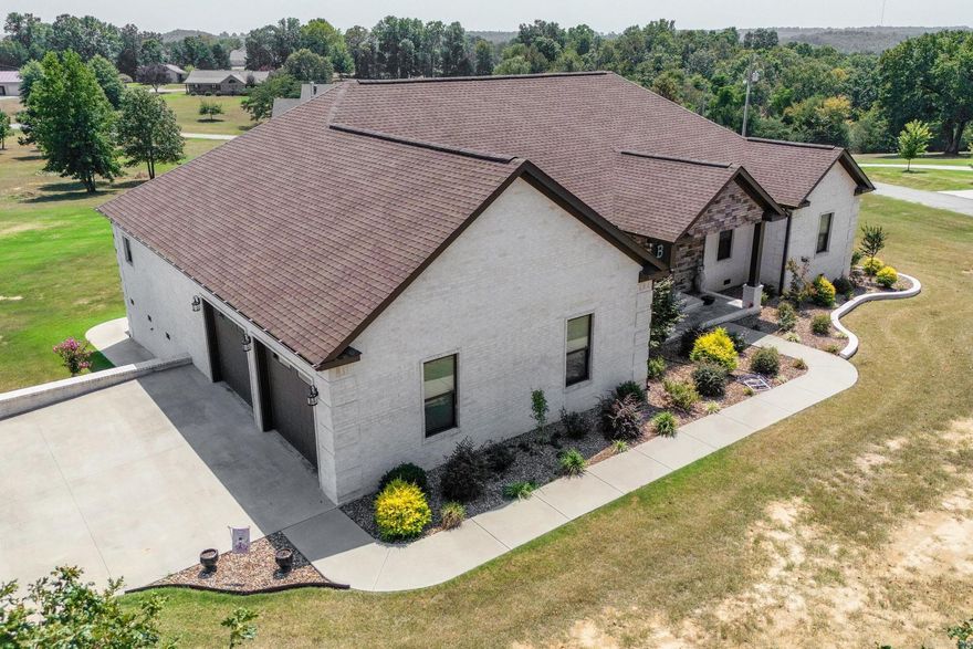 This custom built 2700 sq ft home with an extra 2 car (1400 sq ft) garage should be on your wish list!  Seller purchased an extra lot to ensure privacy and ample space for whatever you want to do!  This home is in a newly developed subdivision with several new homes around!  Wood floors and tile are throughout the home for those who have alergies, tall ceilings and beautiful crown molding ads to this home's beauty.  The formal dining rm is located just across from the kitchen and if the need is a 4th bedroom it could be made into one.  The kitchen offers LOTS of space and cabinets for storage and an island bar for those "on lookers"  that like to help in the kitchen.  Split floor plan, the attached garage is extra wide and extra deep for those bigger vehicles, safe room off of the garage. The crawl space offers extra storage also and the piers supporting the house are double blocked, vapor barrier is in place.  Words and pictures really do not replace an "in person" look at this home!  Call for your tour today.