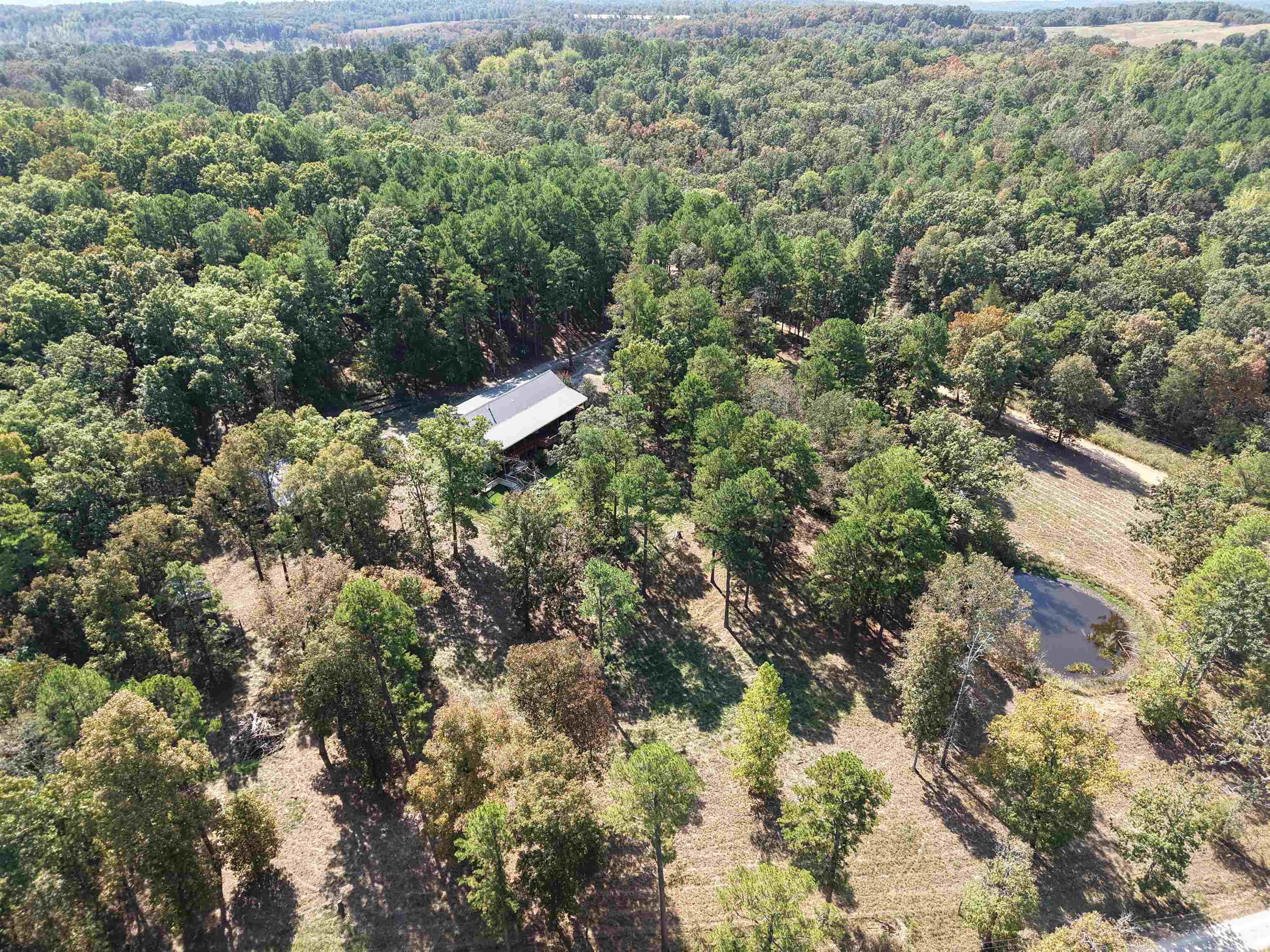 Welcome to this spacious 4-bedroom, 3-bathroom custom-built home on 5.68 acres, ideally situated between Melbourne and Mountain View, Arkansas. Just 20 minutes from the White River, this property offers both convenience and rural country living. Surrounded by beautiful large timber, the setting provides privacy and a scenic backdrop. The property features nice, covered porches, a large deck for entertaining, a fenced-in area for livestock, a nice pond, and multiple spacious outbuildings. The yard is secured with chain-link fencing, making it ideal for pets and family. Inside, the home boasts a spacious layout. The main level includes three bedrooms, a large utility room, and a cozy gas log fireplace, while the walkout basement offers an additional room that can be used as a fourth bedroom, a woodburning stove, and a secure safe room for peace of mind. Listed at $375,000, this property is an excellent opportunity to own a custom country home with modern amenities in a highly desirable location.