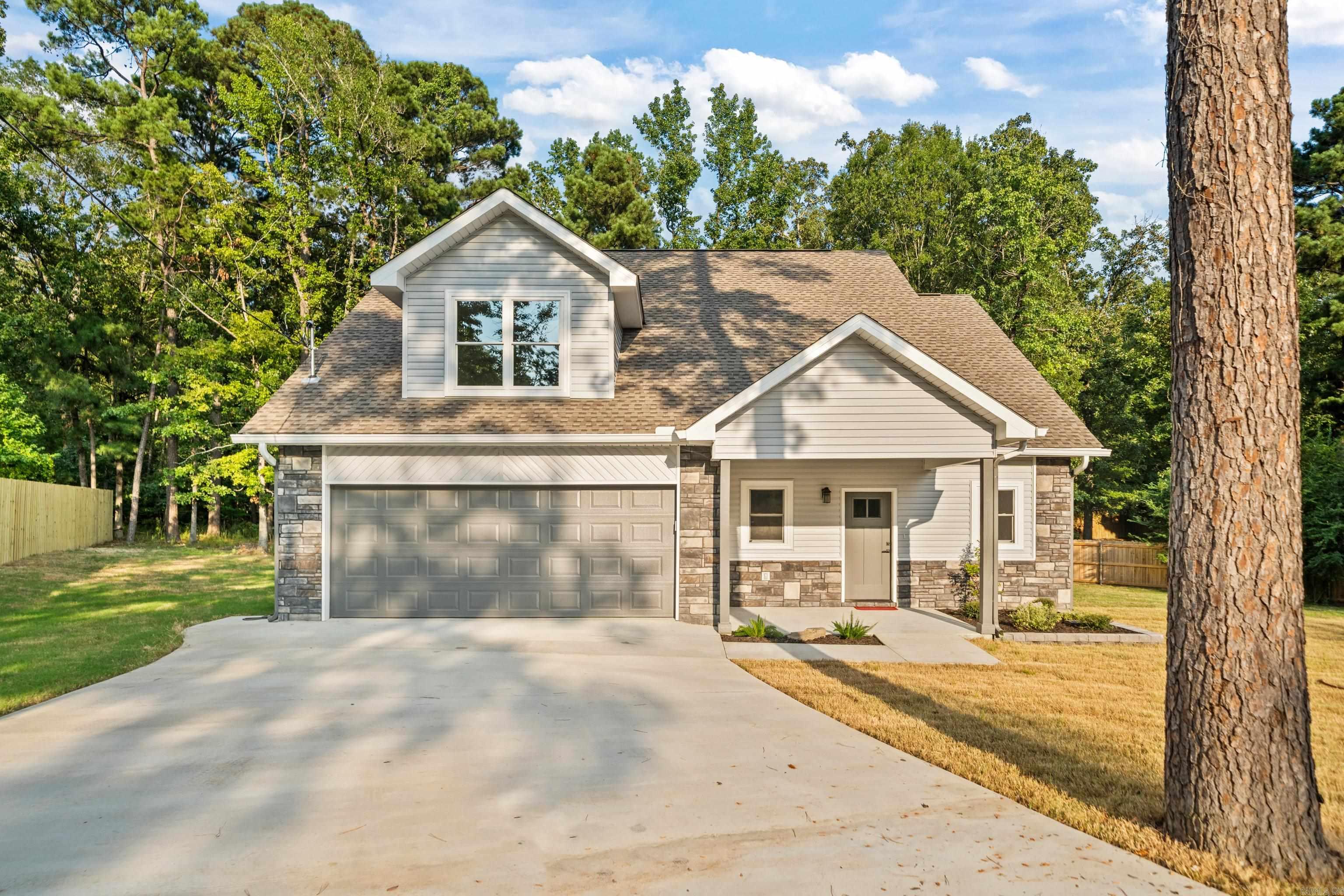 This beautifully crafted new construction residence offers 3 spacious bedrooms, 2 and a half bathrooms, and a thoughtfully designedopen-concept floor plan perfect for modern living. Step inside to discover an expansive living area that seamlessly connects the kitchen,dining, and family room—ideal for entertaining and everyday comfort. The heart of the home features stylish finishes, abundant naturallight, and luxury vinyl flooring throughout the main living spaces. The large primary en suite is conveniently located on the main level,offering a private retreat with a walk-in closet, dual vanities, and a custom-tiled walk-in shower. Secondary bedrooms are generouslysized and positioned for privacy, making this layout functional for families, guests, or home office needs. Enjoy year-round outdoor livingon the covered back patio, surrounded by mature trees that provide both beauty and privacy. Whether you're sipping your morningcoffee or hosting a weekend barbecue, the natural setting is sure to impress. Additional highlights include a two-car garage, and energy-efficient systems.This home combines the serenity of a wooded setting with the convenience of being minutes from Lake Hamilto