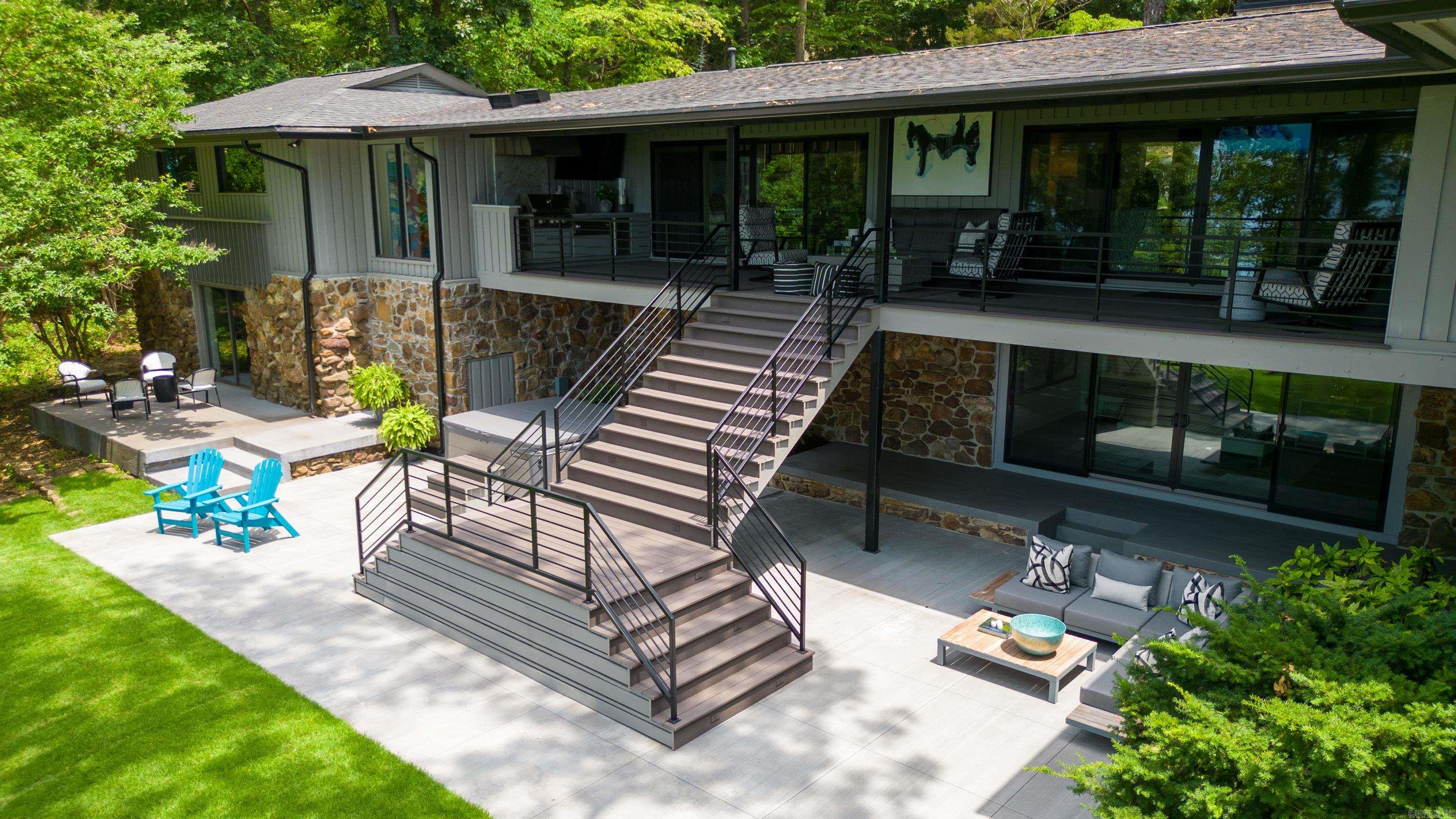 Eden Isle LAKEFRONT with probably one of the best views on the island. Welcome to your dream designer home in Eden Isle on Greers Ferry Lake! This exquisite waterfront property is a masterpiece of modern architecture and luxury, nestled in a serene and picturesque location on the shores of Greers Ferry Lake. Every aspect of this home has been meticulously designed and crafted, creating a harmonious blend of sophisticated elegance and comfortable living. This furnished home features 4 bedrooms, 4 baths & 2 half baths, gourmet kitchen, 2 living areas, great deck with outdoor kitchen, wet bar, large stone fireplace, 2 car garage and a 5 minute cart ride to Eden Isle Marina & Red Apple Inn. So much to see with home and you will not be disappointed!