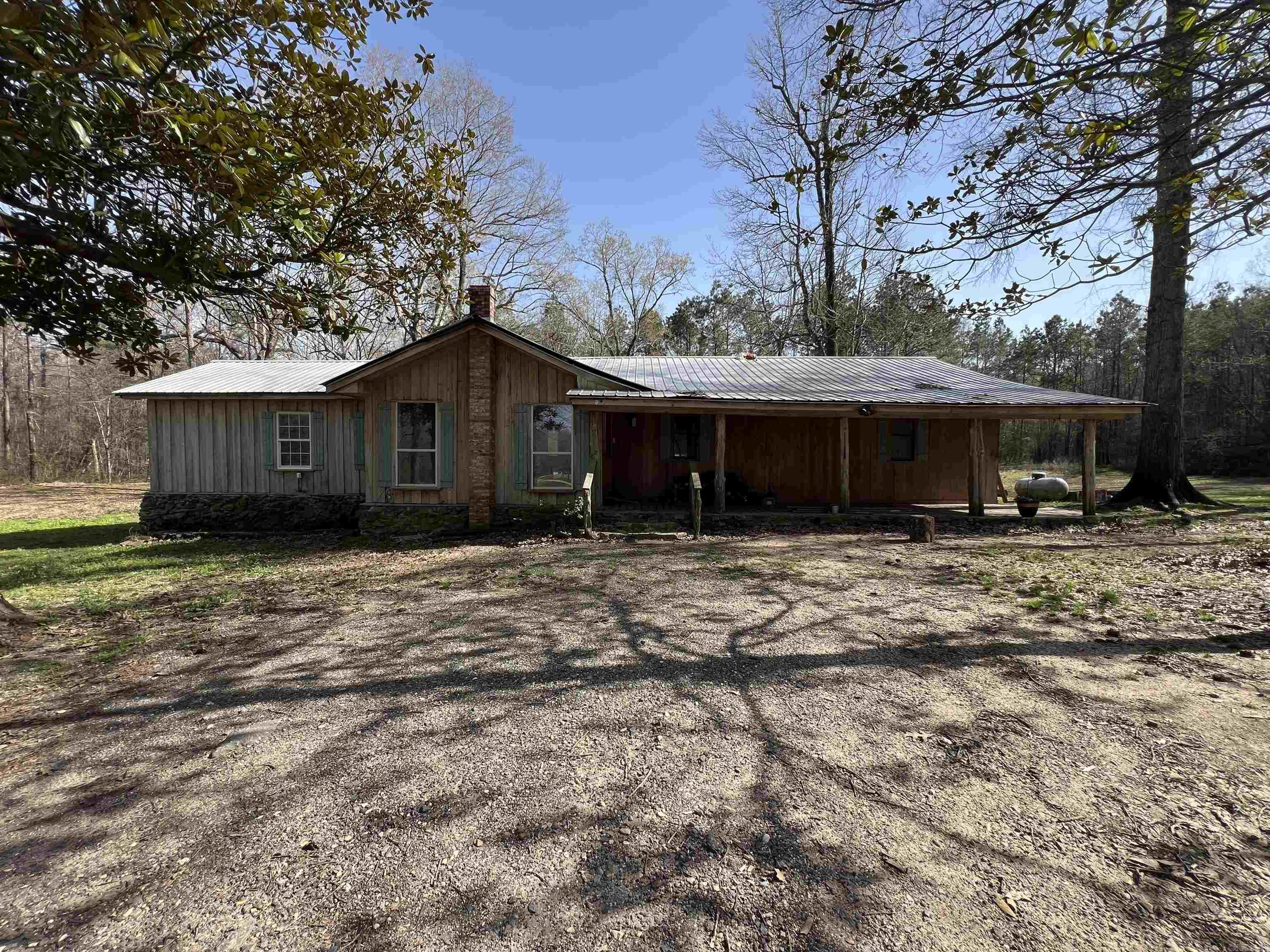 A country lovers dream home! This 3 bed, 2 bath, split floor plan includes 17.45 acres. Spacious rooms and closet space. Also offers a sunroom or utilized as office or as possible untraditional 4th bedroom. Come sit out on the covered front porch and enjoy the great outdoors with family and friends. So much to love!!