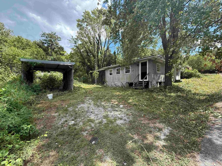 Opportunity knocks! This home sits on a spacious .73 acre lot right in town with city water and regular septic already in place. The home is in need of significant renovation but offers tons of potential for the right buyer or investor. With its large lot size, central location, utility connections, and no restrictions, this is a rare chance to create value and bring new life to the property.