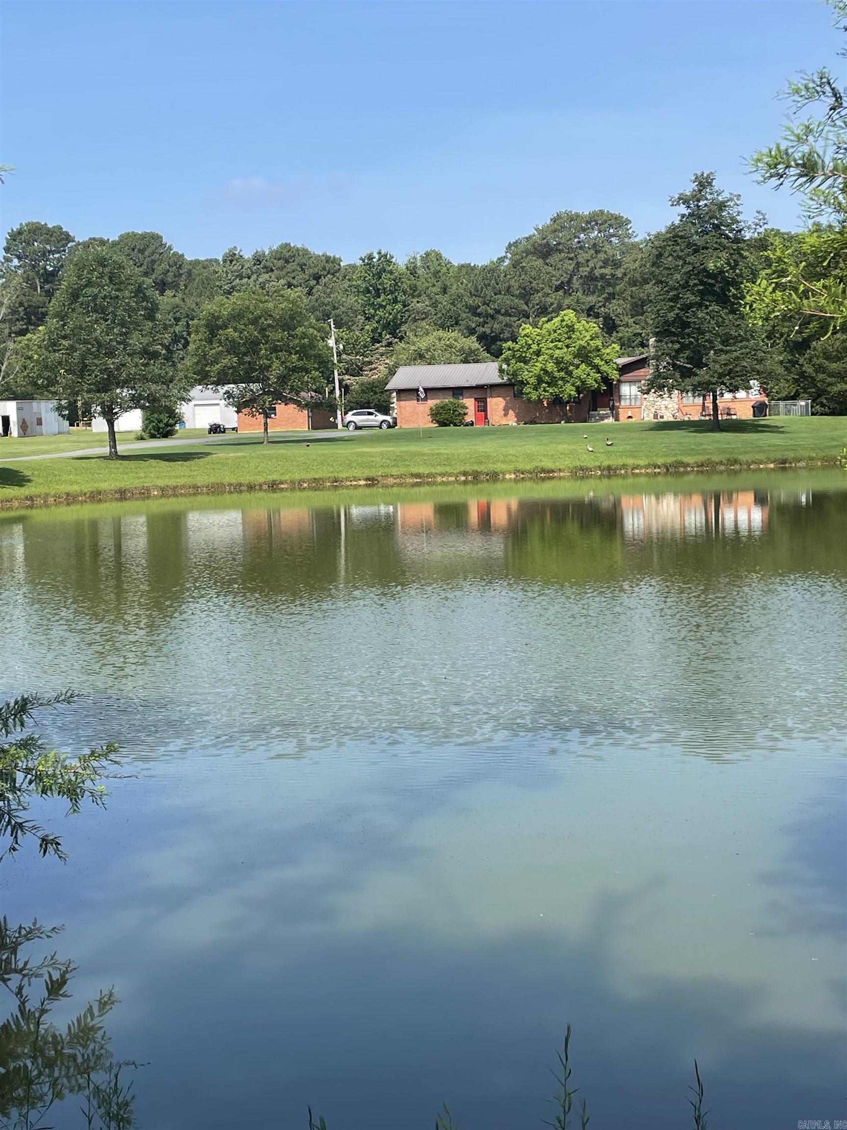 THIS PROPERTY HAS SO MANY DETAILS....I DON'T KNOW WHERE TO START BUT HERE GOES...8.94 ACRES...STOCKED POND...YEAR ROUND CREEK...1800 SF METAL SHOP/2 BAY DOORS/OFFICE...BRICK SHOP W/CONCRETE FLOORS/2 ROOMS/GAS HEAT/ELECTRICITY....SMALLER METAL SHOP WITH 1 DOOR/WALK-THRU DOOR/ELECTRICITY....IN-LAW QUARTERS ARE PLUMBED FOR KITCHENETTE AND FULL BATH...2 CAR ATTACHED GARAGE HAS BEEN USED AS A GAME ROOM (HAS A SEPARATE MINI-SPLIT UNIT) WITH HALF BATH....NOW ON TO THE MAIN HOUSE....ABSOLUTELY GORGEOUS HOME WITH TONS OF UPDATES....KITCHEN HAS TILE COUNTERS/NEW RANGE....BEAUTIFUL ORIGINAL WOOD PARQUET FLOORS IN DINING ROOM...LIVING ROOM WITH ROCK FIREPLACE AND VAULTED CEILING HAS EXPOSED BEAMS....PRIMARY BEDROOM WITH EN SUITE BATH....BEAUTIFUL VIEWS FROM THE HEATED/COOLED SUNROOM...SMALL AREA OF THE BACK YARD IS FENCED WITH CHAIN LINK. ..AND I SAVED THE BEST FOR LAST.....YOU CAN HAVE YOUR VERY OWN RC RACE TRACK!!!! COMPLETE WITH SPECTATOR AREA AND JUDGES BOOTH!!! MOVE FAST BEFORE THIS ONE GETS AWAY!!
