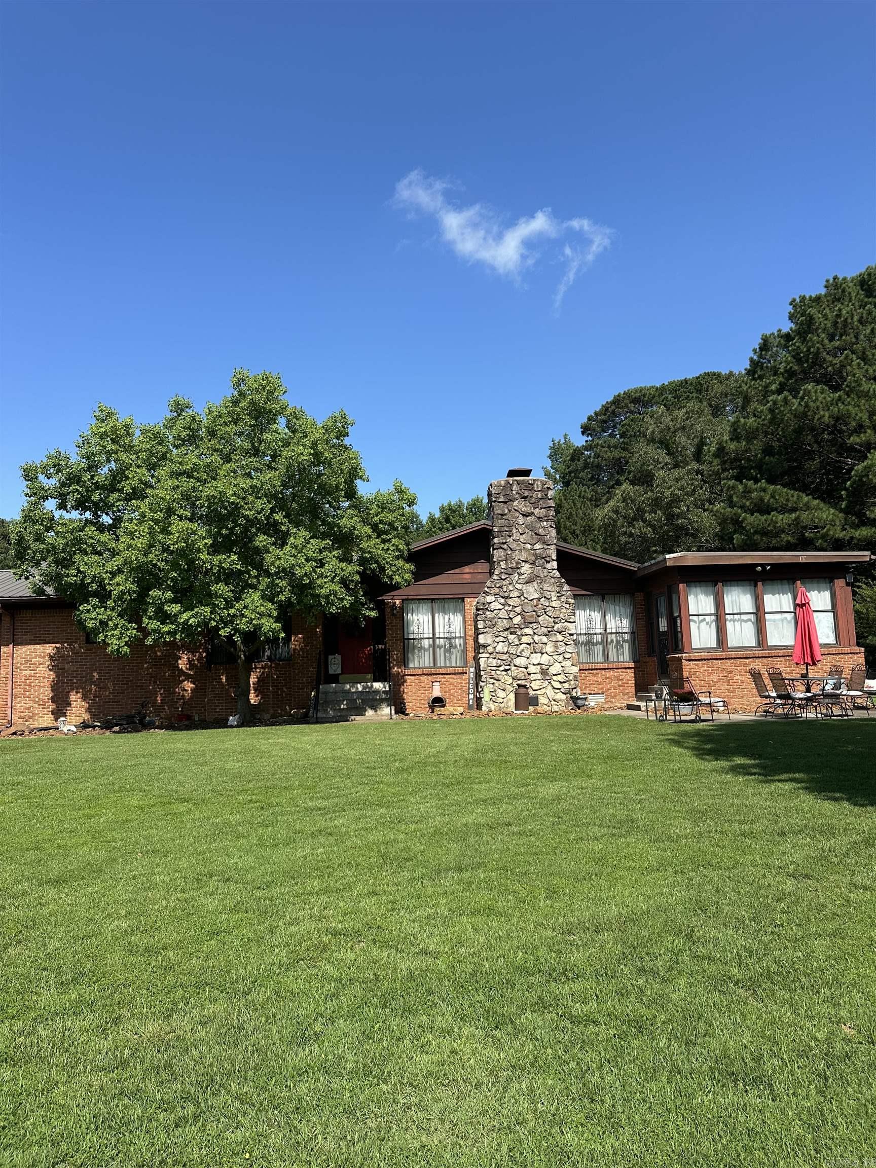 THIS PROPERTY HAS SO MANY DETAILS....I DON'T KNOW WHERE TO START BUT HERE GOES...8.94 ACRES...STOCKED POND...YEAR ROUND CREEK...1800 SF METAL SHOP/2 BAY DOORS/OFFICE...BRICK SHOP W/CONCRETE FLOORS/2 ROOMS/GAS HEAT/ELECTRICITY....SMALLER METAL SHOP WITH 1 DOOR/WALK-THRU DOOR/ELECTRICITY....IN-LAW QUARTERS ARE PLUMBED FOR KITCHENETTE AND FULL BATH...2 CAR ATTACHED GARAGE HAS BEEN USED AS A GAME ROOM (HAS A SEPARATE MINI-SPLIT UNIT) WITH HALF BATH....NOW ON TO THE MAIN HOUSE....ABSOLUTELY GORGEOUS HOME WITH TONS OF UPDATES....KITCHEN HAS TILE COUNTERS/NEW RANGE....BEAUTIFUL ORIGINAL WOOD PARQUET FLOORS IN DINING ROOM...LIVING ROOM WITH ROCK FIREPLACE AND VAULTED CEILING HAS EXPOSED BEAMS....PRIMARY BEDROOM WITH EN SUITE BATH....BEAUTIFUL VIEWS FROM THE HEATED/COOLED SUNROOM...SMALL AREA OF THE BACK YARD IS FENCED WITH CHAIN LINK. ..AND I SAVED THE BEST FOR LAST.....YOU CAN HAVE YOUR VERY OWN RC RACE TRACK!!!! COMPLETE WITH SPECTATOR AREA AND JUDGES BOOTH!!! MOVE FAST BEFORE THIS ONE GETS AWAY!!