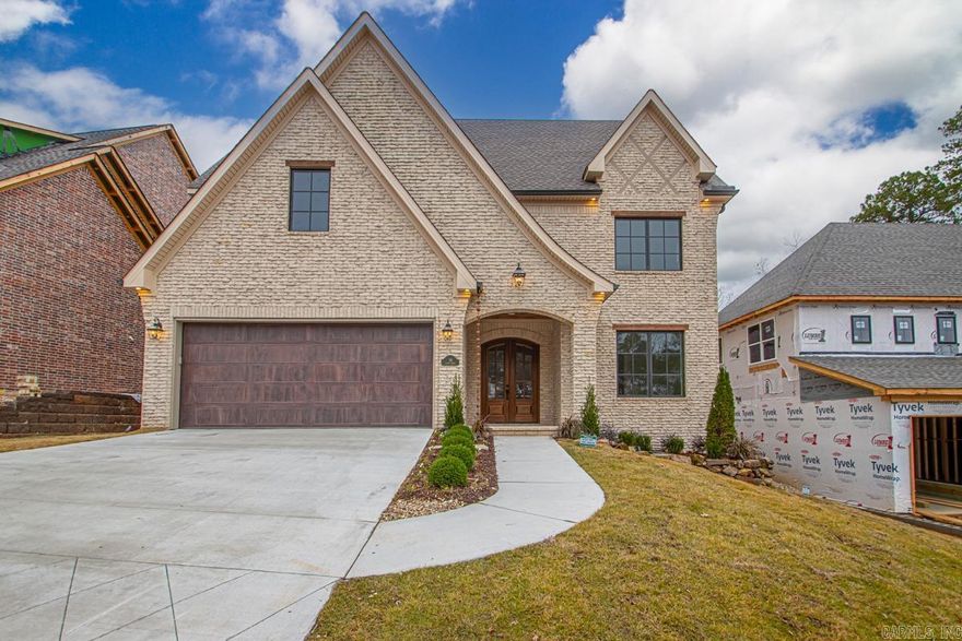 This custom-built French-style transitional home blends timeless elegance with modern comfort, offering 4 bedrooms, 4.5 baths, and a large media room (or 5th bedroom) with over 3,900 sqft in Chenal. Showcasing weeping mortar brickwork and high-end finishes throughout, the design is elevated by Sierra Pacific wood-clad windows that flood the home with natural light. The gourmet kitchen with a large pantry, two laundry rooms, and an extra-large bonus space provide both luxury and functionality. Dog lovers will enjoy dedicated indoor and outdoor bathing areas along with a secure built-in space for their pets. This home also features full insulation encapsulation and a 21 seer state of the art heating and air system. A quiet backyard with green space for relaxing or entertaining, and just minutes from shopping, dining, and Pinnacle Mountain, this home truly has it all.