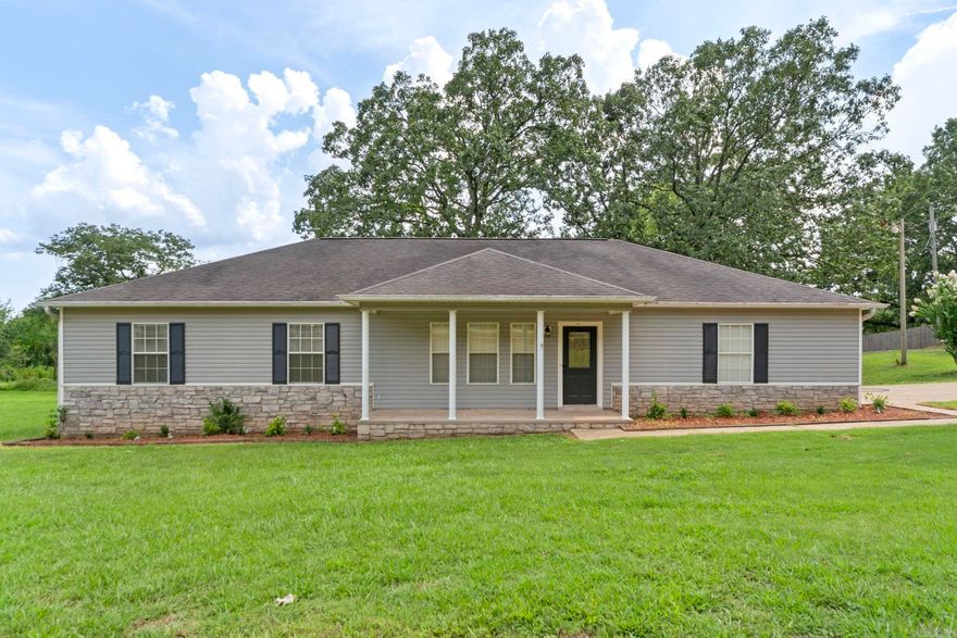 PRICE REDUCED! This stunning home features fresh paint, new light fixtures, updated flooring, a new HVAC system, and so much more. It's move-in ready with 3 bedrooms, 2 full baths, a gorgeous kitchen, a vaulted ceiling in the living area with a fireplace, spacious closets, a tray ceiling in the master bedroom, a separate laundry room, and a bonus room perfect for an office. The property includes a double garage and a backyard shop designed for cookouts. Situated on a corner lot, this home sits on 1.14 acres, or for additional cost you can purchase with 2.84 ac