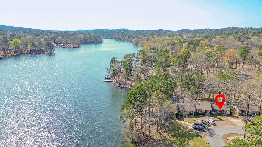 Wake up to stunning WATERFRONT views on beautiful Lake DeSoto! This fully furnished 3-bedroom END-UNIT offers the perfect mix of relaxation, recreation, and income potential with a proven successful short-term rental history. Enjoy incredible sunsets from your private back deck or lower patio, or walk down to your own boat/swim dock and head straight onto the lake. The sale even includes two kayaks with all the gear, making it a truly turnkey lake getaway. Inside you'll find an updated kitchen with granite countertops and new appliances, perfect for entertaining after a day on the water. New LVP flooring and carpet. The main-level also includes the primary bedroom with deck access and a full bath, while the lower level offers two additional bedrooms and full bath—ideal for family or guests. An oversized laundry/storage/owner’s room provides space for personal belongings. The home is fully equipped for vacation rentals, including extra linens, dishes, silverware, cookware, and everything needed for guests, allowing income from day one. Hot Springs Village has a $2000 new owner buy-in fee.