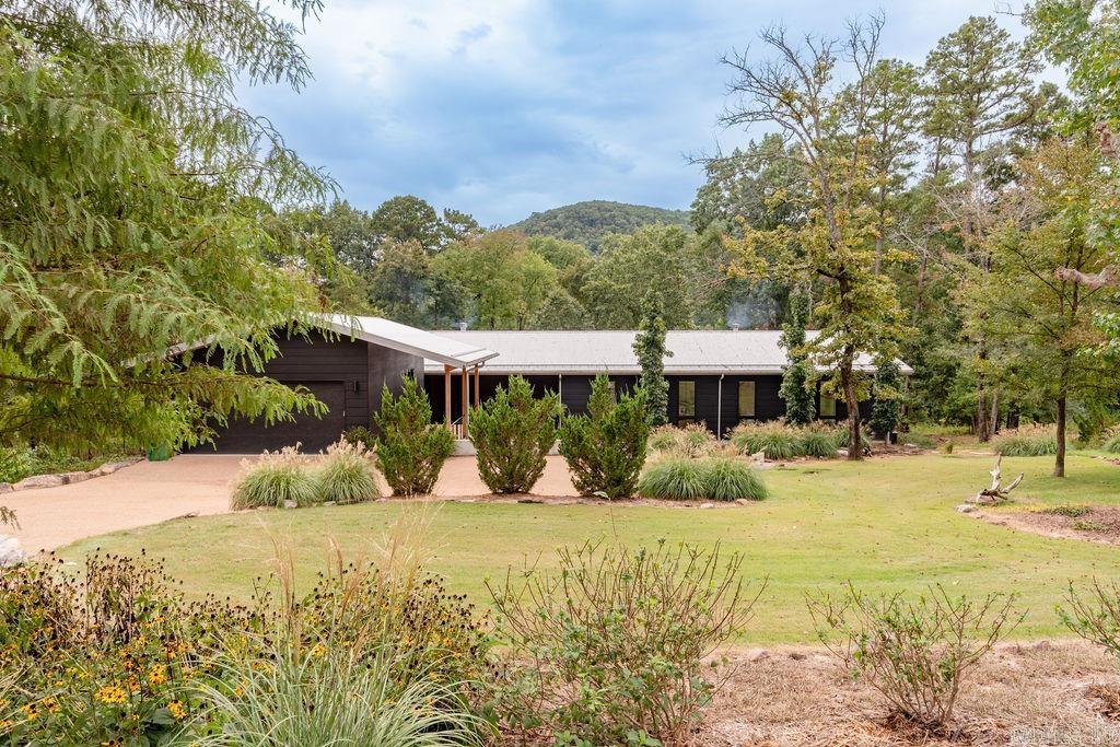 A flawless blend of architectural perfection, aesthetics and comfortable practicality, also featuring a world renown artist piece in the custom stained glass window greeting you at the front entry. Add the location, world-class trout fishing on the Little Red River and the amenities of the Primrose Creek community and the result is a modern home that you will never want to leave. Low maintenance design and construction with sweeping views of the beautifully landscaped grounds and the river. Indoor spaces invite the outdoors in while maintaining privacy and comfort. Ground level walk-in space is even climate controlled and the house is pre-wired for a whole-house generator. Easy walk to the private boat dock with lift in the covered slip. Primrose Creek amenities include a spectacular pool and gathering area, community boat dock, launch ramp, warm water fishing lake and lots of open green space with views of Libby Bluff across the valley. Primrose Creek is minutes from marinas on Greers Ferry Lake, shopping, services and health care in Heber Springs. Arrange a showing by appointment to see this one of a kind private resort. See Agent Remarks.