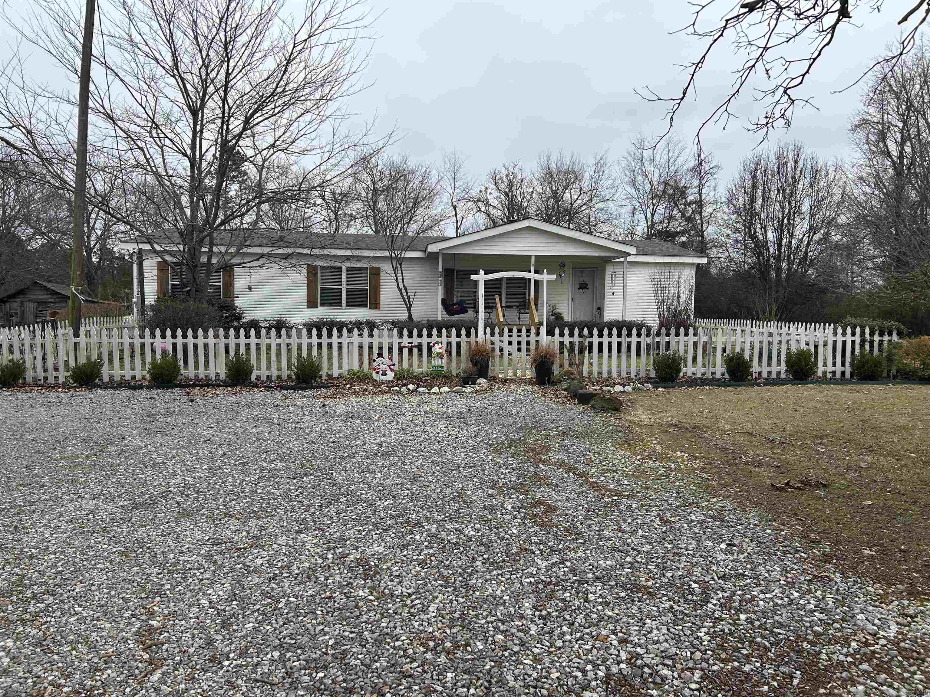 This beautiful 3 bed, 2 bath home is move in ready. The home has a welcoming front porch and a covered back patio as well as a huge yard that sits on 2 beautifully maintained acres. The living room is so inviting with a wonderful log burning fireplace. Refrigerator, washer, dryer, deep freezer and free-standing heater convey with the property at -0- cost. All furniture in the house is negotiable. There is also an 18 x 26 shop. Roof was replaced 1 year ago, septic cleaned out 6 months ago, and water heater replaced 2 years ago. There is also a deer lease available across the way. County Living at its finest!