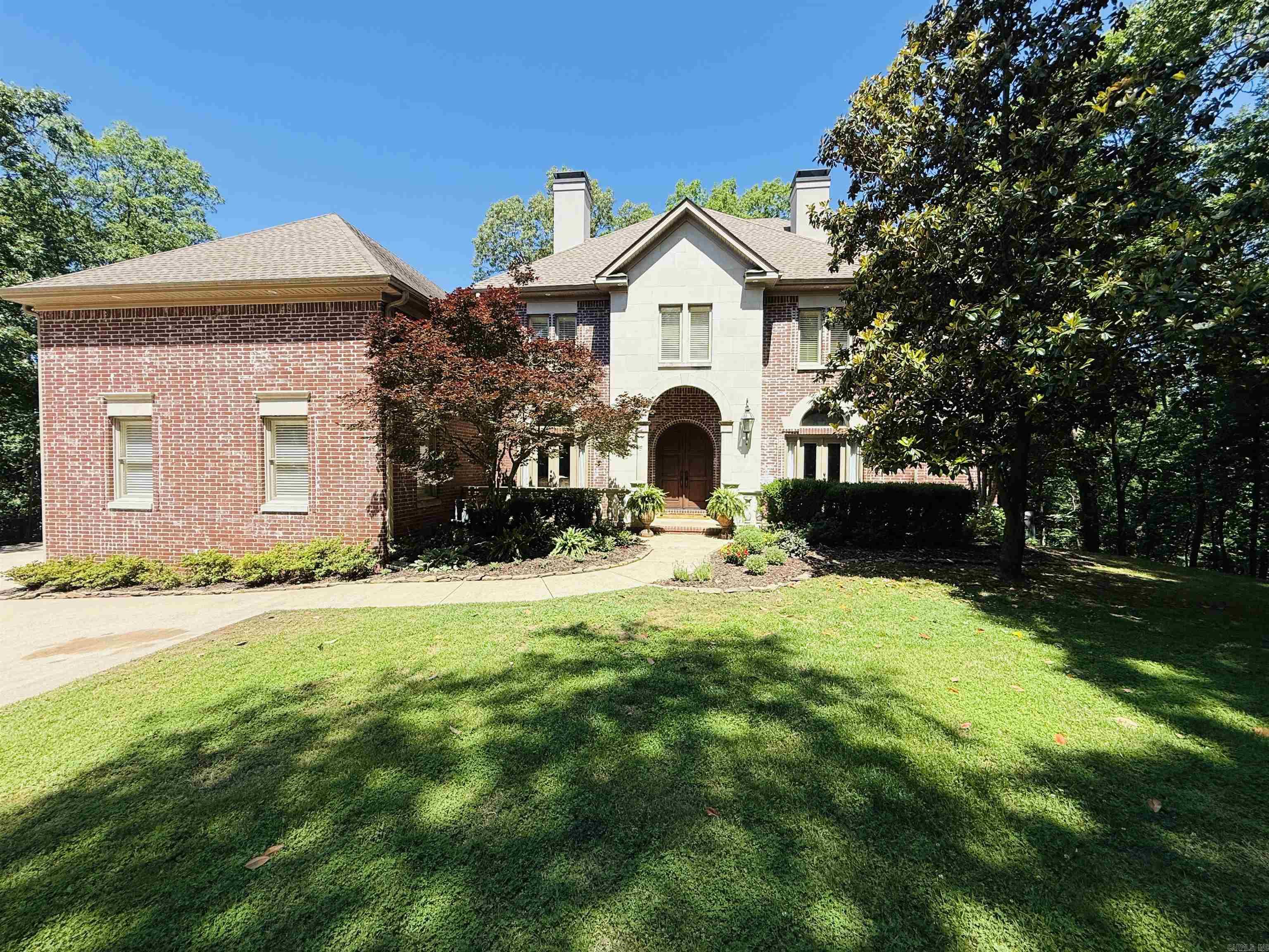 Nestled in the desirable Chenal Downs subdivision, find this beautiful, custom-built home surrounded by nature. The entry is highlighted by a curved staircase, office, half bath, formal living room, formal dining room w/wood-burning fireplace w/two story windows overlooking a lush valley. The kitchen is chef's delight for entertaining w/granite countertop, top of line appliances, bkft bar & separate bkftrm w/built-in cabinetry. The hearth room is perfect family retreat w/wood-burning fireplace. Located nearby is the laundry room with sink, built in cabinetry, half bath w/access to the pool. The primary suite is on the main level and features a lovely sitting area that opens to an outside balcony. Enjoy double vanities, a jetted tub, separate shower & two walk in closets in primary ensuite bath. Upstairs are 3 BRs w/ensuite bathrooms and walk-in closets. Additional rooms are a gameroom with built-in storage, bonus room, nook w/built-in desk & bookcases and 2 lg closets that are heated & cooled plus walk out floored attic. Outside find the perfect place for entertaining & family gatherings in the inground pool & patio which insures complete privacy. Come see this lovely home!
