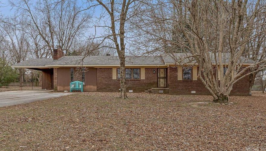 Nestled on 1.55 peaceful acres, this inviting 3-bedroom, 2-bath home offers over 2,000 square feet of comfortable living space. Located just barely off a paved road- with very minimal gravel travel- you’ll enjoy a quiet country setting while remaining conveniently accessible.  Inside, most of the home has been tastefully updated with fresh paint and new flooring, creating a bright, welcoming feel throughout. The kitchen features new flooring and offers an excellent opportunity for future personalization. A cozy den with a woodburning fireplace, a separate living room, and an additional room at the back of the home provide flexible space for a home office, hobby room, playroom, or second den.  Outside, enjoy the land, a shop, storage building, and an outdoor storm shelter for added peace of mind. The roof was replaced in 2022, adding long-term value and durability.  With generous square footage, multiple living areas, and practical outbuildings, this property offers space, comfort, and versatility in a peaceful setting. (See agent remarks)