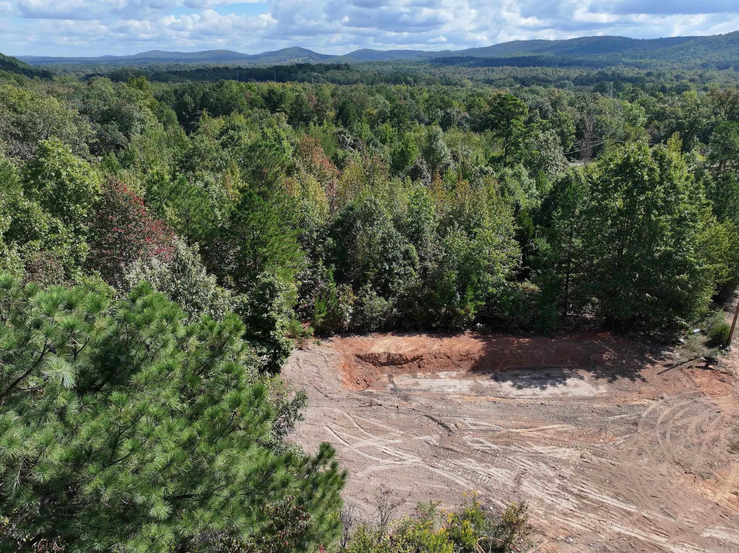 Discover the potential of this 5+/- acre property nestled at the base of Mt. Riante. Offering a blend of open and wooded areas, this versatile land provides plenty of possibilities. A mobile home is included with the sale and being SOLD AS-IS. Conveniently located just outside city limits, only minutes from local amenities.
