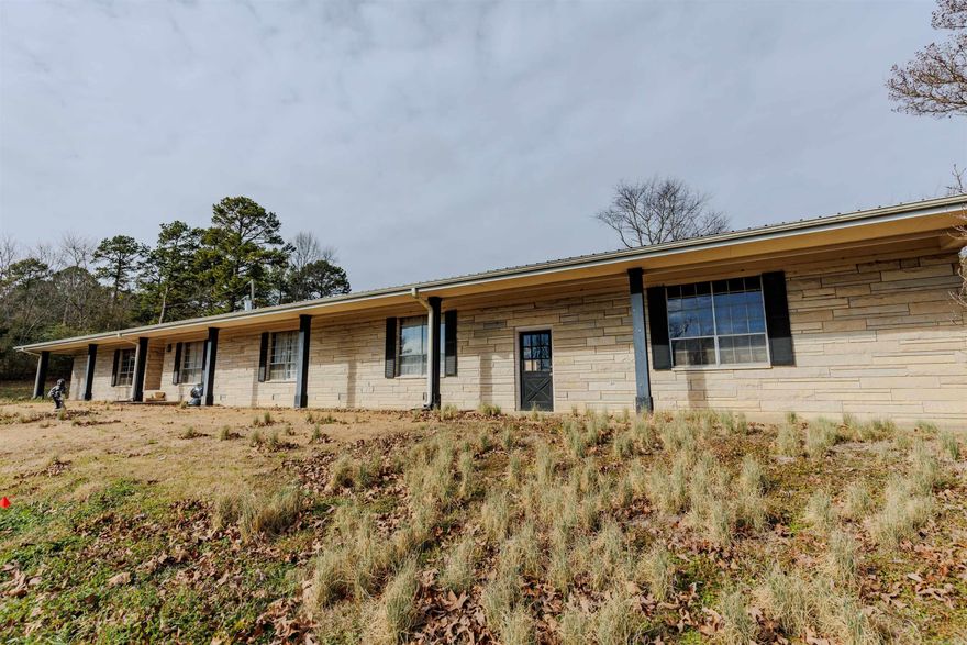 Large 4 bedroom, 3 full bath, ledge stone ranch home on 8.59 acres with a spectacular view! Long, paved driveway off Hwy 64, 3.5 miles from downtown Morrilton and 20 mins to downtown Conway.  Large kitchen with great potential! Super large bonus room for kids or adults to enjoy! Open great room with fireplace that attaches to kitchen. Full length sun room with hot tub, utility sink and space for any activity! Whole house generator, metal roof, large double car garage & storage, fenced back yard, and chicken coop!  Lots of potential and ability for multi generational living.  Master suite and bath on one end - 3 bedrooms and 2 baths on the other end. Pasture for horses and livestock and hunting ability on wooded section of property which includes a seasonal creek. Definitely need updates and repair/remodel of floors, master bedroom and bath, and laundry room (new flooring in boxes is included). Bring your vision and skills and make this into the grand house it can be!!   House will be sold "AS-IS, WHERE-IS" as price reflects. New owners can subdivide and sell lower portions of land and still have large beautiful yard with view!   *** Agents - please see remarks ***