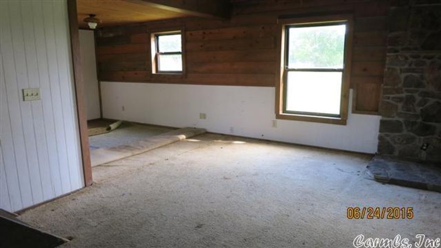 2 story house  with  rustic wood interior, loft and open 2 story  living room.  It needs repairs and remodeling, but what a gorgeous setting. The potential for a really nice home in the country is there. Living room and kitchen are an"open" style floor plan.  Bathroom and 1 bedroom on the main level. Upstairs is a second bathroom area-not yet finished-- and 2 areas that can easily be used for sleeping areas, family room or what have you.  No heating or cooling systems. Homesteps Fannie Mae property.