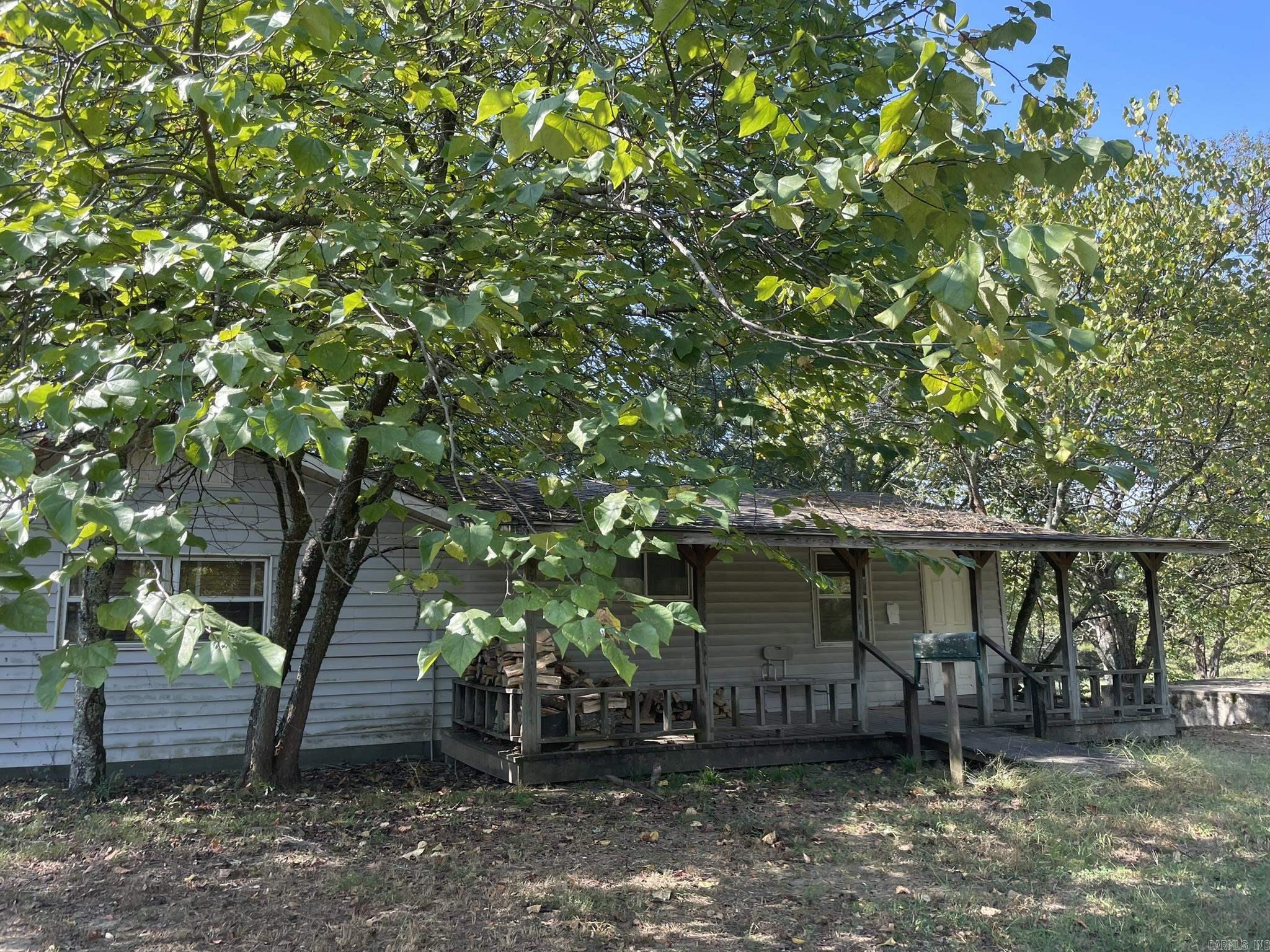 The gated entry on this fantastic 36.24 acres of mixed woods and fields, boasting 2 ponds connected by a private creek, leads to a 1,245sf fixer-upper house with a 27x20 deck inside a chain link fenced backyard, and a storm shelter. You will also find on this fully fenced property a barn, shop, and pole sheds ready for livestock, if that's your pleasure. Agents see remarks