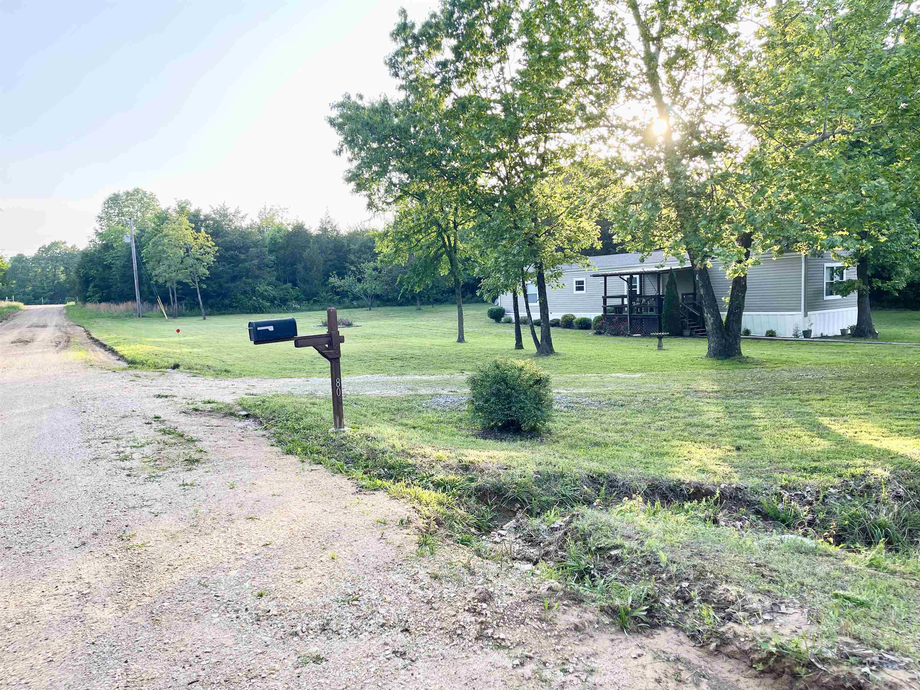 Peaceful Country Living – 2 Bed, 2 Bath on 1.22 Acres – No Restrictions! Welcome to your private slice of the countryside! This charming 2-bedroom, 2-bathroom mobile home offers 1,152 sq. ft. of comfortable living space on a generous 1.22-acre level lot with county road frontage – all with no restrictions! Step inside and enjoy a bright, functional layout perfect for relaxed living or easy entertaining. The spacious living area is complemented by a cozy propane fireplace, offering backup heat to the efficient central heat pump system. You'll love the walk-in shower, screened-in back porch, and county water convenience paired with a private septic system. Whether you're looking for a peaceful retreat, your first home, or a savvy investment, this property has the flexibility to fit your vision. The screened-in back porch is perfect for enjoying quiet mornings or watching the sunset. Plus, there’s a storage building on-site for tools, equipment, or hobby gear. Bring your animals, start a garden, or park your RV – this is unrestricted rural living at its best. Homes like this with land and freedom at just $125,000 don’t last long! Call today to schedule your private showing!