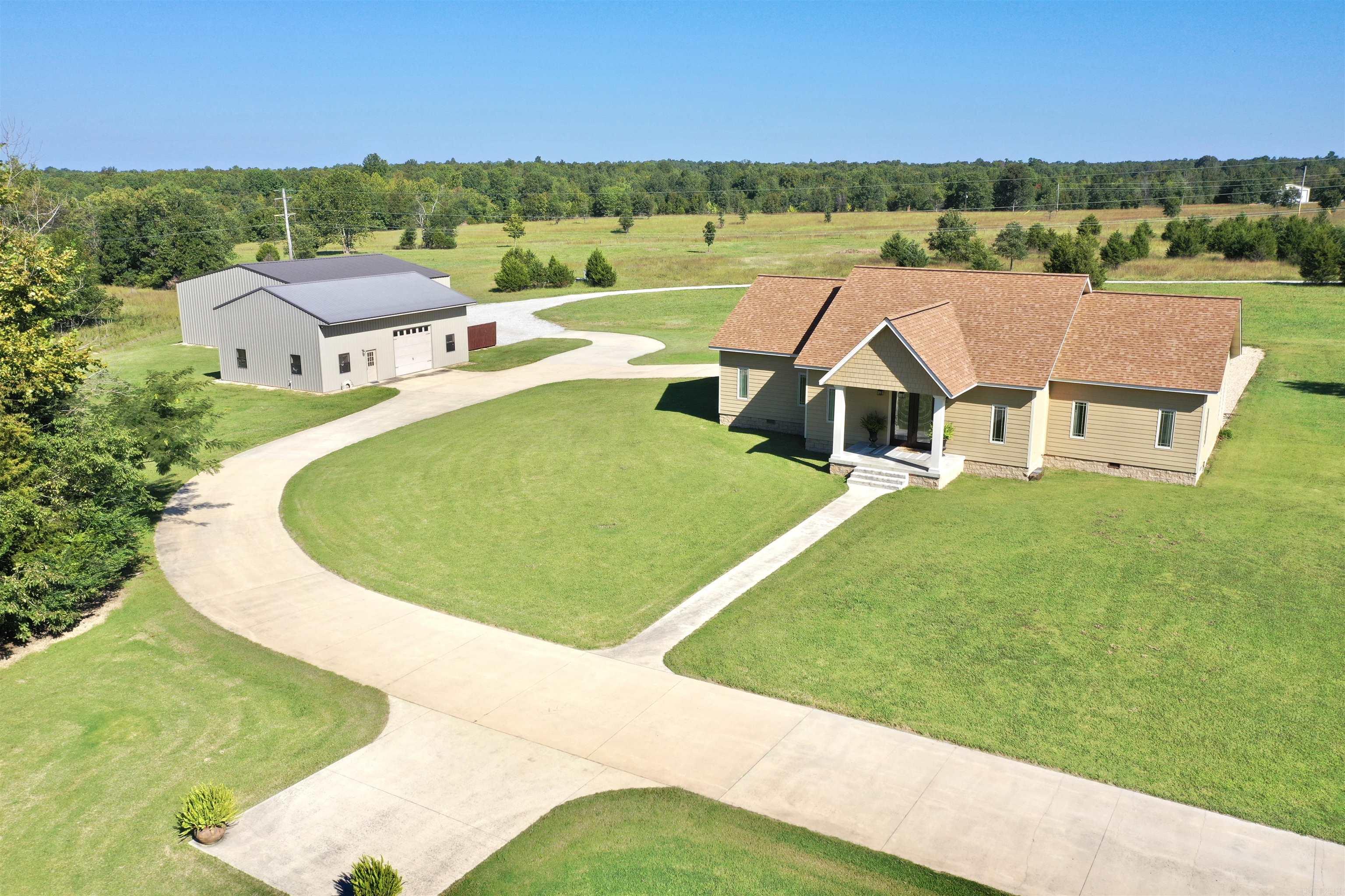 STUNNING, WELL MAINTAINED HOME located in Viola! This 3 bedroom, 2.5 bath home sits on a manicured 20 acre tract. From the moment you pull into the driveway, walk up the steps & into the front door, you immediately notice the unique custom characteristics of this home. This home features an open floor plan with a custom kitchen offering stainless appliances, granite countertops, large island, & walk in pantry/coffee bar. Formal dining area plus an additional sitting area with gas fireplace insert. The Master suite offers a large bedroom with sitting area, walk in closet, & full bathroom with soaking tub and walk in shower. Located off the kitchen is a large Sunroom with access out to the back patio where you can sit pool side at an inground salt water pool. There is a 30x50 shop with a studio apartment offering a kitchen, living area, & full bathroom. Additional 50x50 red iron storage building, 2 ponds, orchard, & a 1 vehicle attached garage. Owner will finance with an agreeable down payment! Call me today to see this beautiful property!