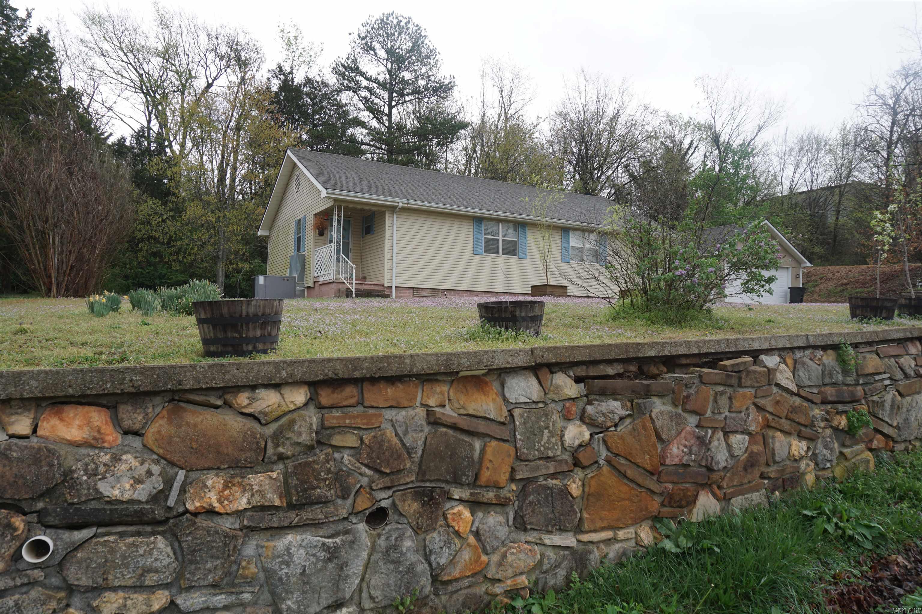 New listing in the beautiful Ozarks! Nice 3-bedroom 1.5 bath home with large, detached shop/garage, and storage building on part of 3 city lots, within the city limits, and in the heart of quaint Marshall, best known for being the front door to the Buffalo National River. The home's inviting and open floor plan offers a living/dining combo with a gas fireplace, white kitchen cabinets with built in oven and stove top, central heat/air, new interior paint, new luxury vinyl plank flooring throughout with exception of the baths, laundry room, and is within walking distance of the Courthouse Square, Post Office, Public Library, pharmacy, churches, banks, coffee/bakery/eateries, boutique shopping, Hardware/Feed Store, hair salons, childcare, Elementary School, Fair Grounds, Rodeo Arena, and Raccoon Springs City Park with a walking trail and small lake for Trout fishing! Priced right for a quick sale, move-in ready, and a great option for retirees, first-time home buyers, singles, and families alike. Great find! Nice neighborhood surrounded by all the natural beauty of the Ozarks offering endless options for outdoor activities and enjoyment!