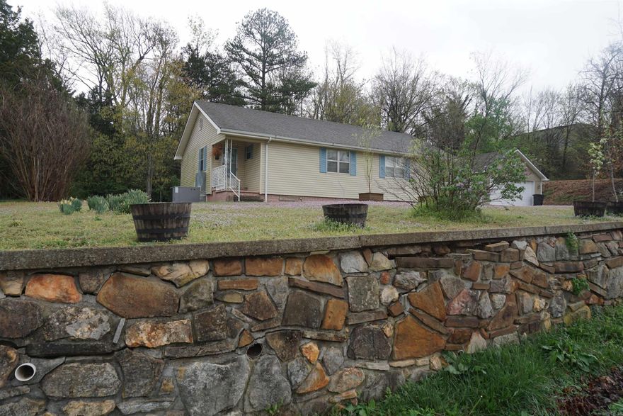 New listing in the beautiful Ozarks! Nice 3-bedroom 1.5 bath home with large, detached shop/garage, and storage building on part of 3 city lots, within the city limits, and in the heart of quaint Marshall, best known for being the front door to the Buffalo National River. The home's inviting and open floor plan offers a living/dining combo with a gas fireplace, white kitchen cabinets with built in oven and stove top, central heat/air, new interior paint, new luxury vinyl plank flooring throughout with exception of the baths, laundry room, and is within walking distance of the Courthouse Square, Post Office, Public Library, pharmacy, churches, banks, coffee/bakery/eateries, boutique shopping, Hardware/Feed Store, hair salons, childcare, Elementary School, Fair Grounds, Rodeo Arena, and Raccoon Springs City Park with a walking trail and small lake for Trout fishing! Priced right for a quick sale, move-in ready, and a great option for retirees, first-time home buyers, singles, and families alike. Great find! Nice neighborhood surrounded by all the natural beauty of the Ozarks offering endless options for outdoor activities and enjoyment!