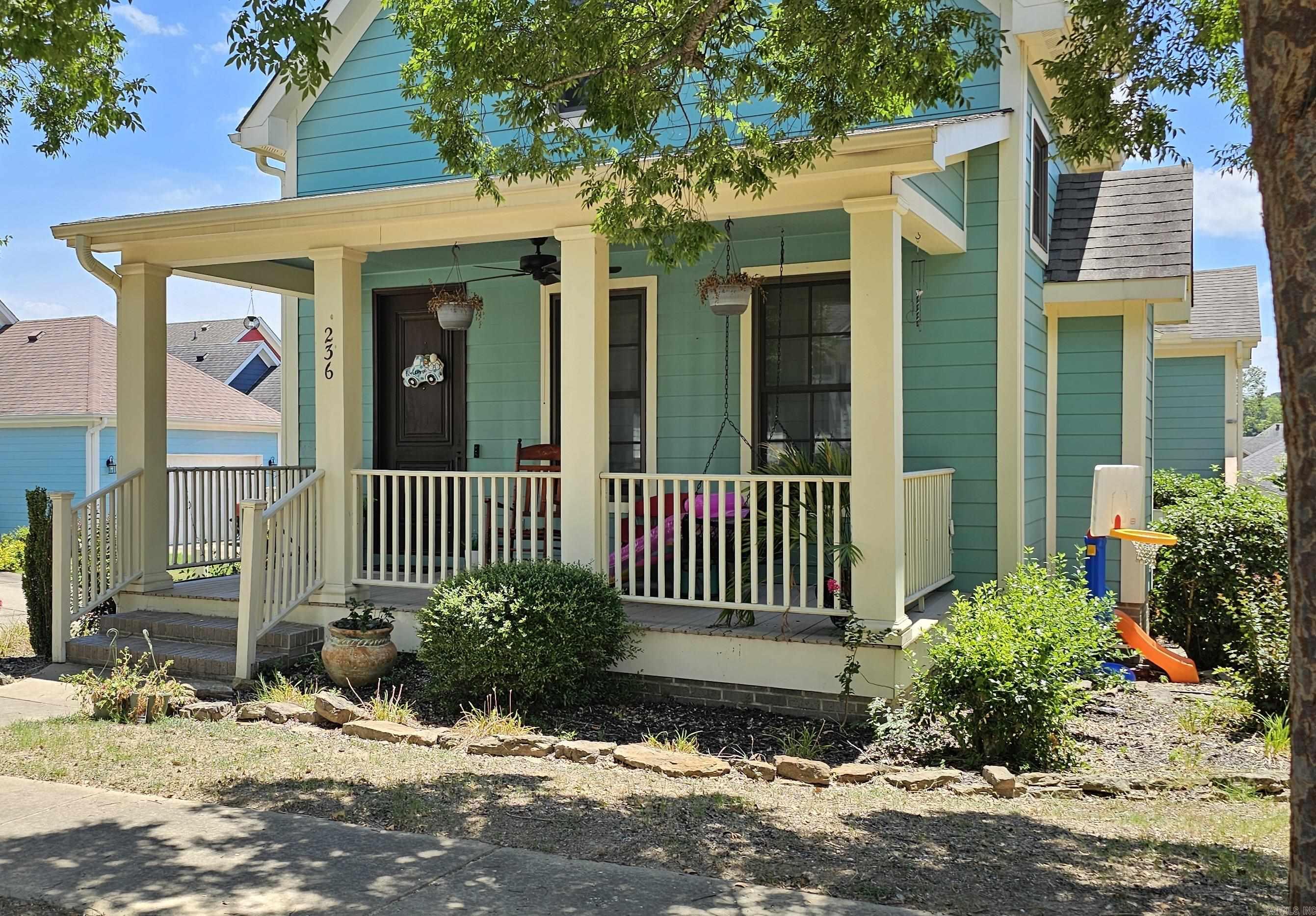 Coastal Charm Across from the Pool! Beautiful 3BR/2.5BA coastal beach-style home with 2-car garage. Main-level primary suite with walk-in closet, vaulted living room with fireplace, and built-in bookcase in the study, plus laundry and extra storage in hallway. Vinyl wood floors, front porch, and side deck for outdoor living. Upstairs features 2 bedrooms, full bath, bonus area. Just steps from the community pool—ideal for year-round living.