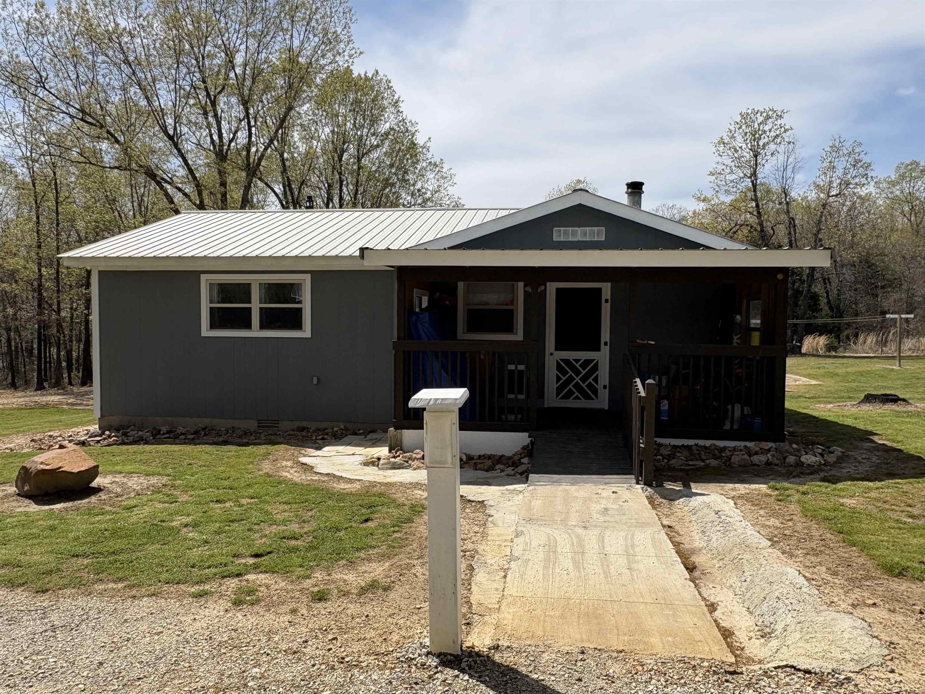 If you are looking for a quiet homestead, look no further. This small home packs a huge punch! The two bed (we are counting the she shed as the second bed) one bath home is in spotless condition. The large family room is a perfect place to unwind in and is conveniently connected to an adorable kitchen. To achieve a third bedroom, just add a wall to the large living room and suddenly you have a two bedroom cabin! The vaulted ceilings opens up the kitchen and laundry room and showcase the galvanized ceilings that fill this home with character and charm. There is a "she-shed" with electricity perfect for a little getaway or extra room for guests. Raise chickens in the 12'3" x 11' chicken coop. Plenty of fenced grazing acres for livestock. Store all your necessities in the 24' x 11' shed. There is also a 18' x 30'9" utility barn. This home offers everything to start your own homestead. Come and see it today! See agent remarks for showings.