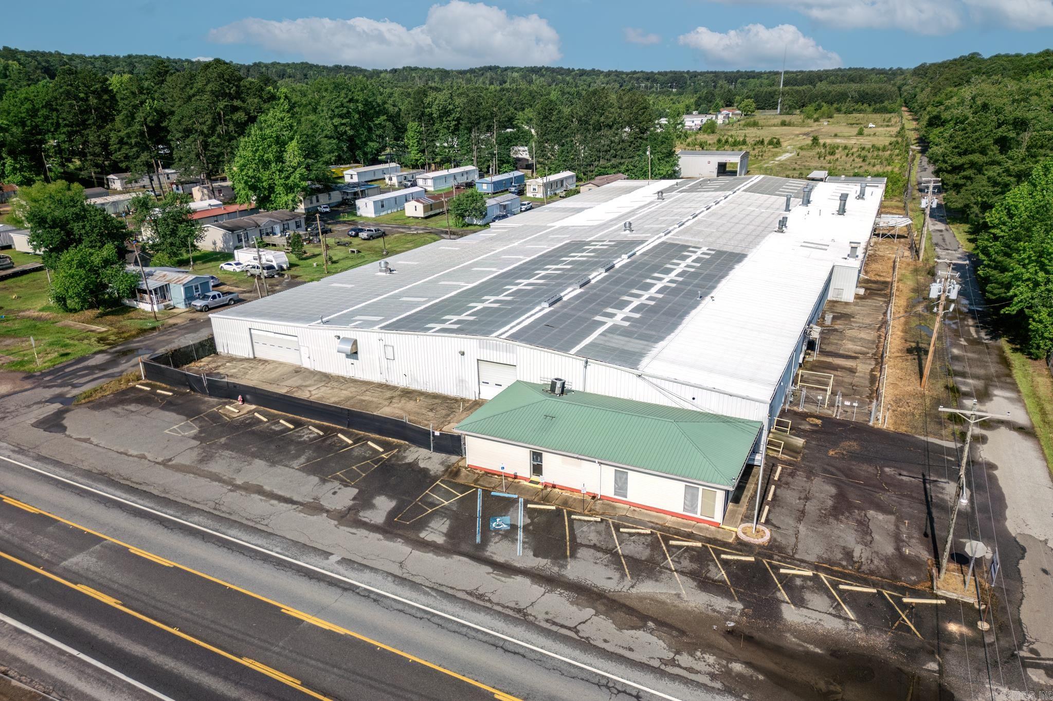 This expansive industrial property in Arkadelphia, Arkansas, presents an exceptional opportunity for your business. Conveniently located just minutes from Interstate 30, the property boasts prominent highway frontage on AR-7. Arkadelphia itself has a highly centralized location only a few hours from major cities such as Dallas, Memphis, Shreveport, and many others. The facility spans a substantial 74,274 square feet, including 1,624 square feet dedicated to office space and 72,650 square feet of industrial floor space. Additionally, there is a 3,000 square foot warehouse, providing ample room for storage and operations. Set on 13.4 +’- acres of fully fenced land, the property offers significant room for expansion to accommodate future growth. Previously utilized as a manufacturing plant, this property is zoned I-1 Heavy Industrial District. This zoning permits a wide range of uses, including the manufacturing, compounding, processing, packaging, or assembling of products. This versatile property, with its strategic location and extensive facilities, is ideal for various industrial purposes and poised to support your business's long-term success.