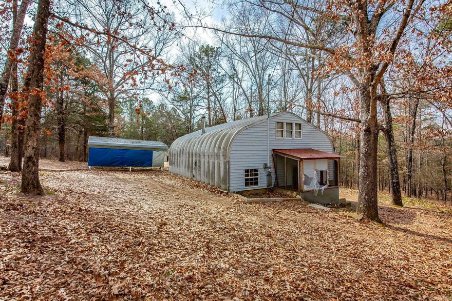Unique Kwanza hut–style home tucked away on beautiful land on Culpepper Mountain. This is one of those peaceful, quiet places where you can truly unplug and feel like you’re miles away from everything — yet still close enough to town when you need it. The split-level, energy-efficient home could use some updating and a little TLC, but it has great bones and tons of potential to be turned into the farmhouse-style retreat you’ve been dreaming about. Outside, you’ll find multiple outbuildings and shops, including a 12x16 shop with electric, a 30x24 shop with electric and a roll-up door, and a 30x30 barn with 10 stalls and storage — perfect for animals, hobbies, equipment, or your next big project. The land is fenced and features a stocked pond, making it ideal for livestock, fishing, or just enjoying quiet evenings by the water. If you’ve been craving space, privacy, and a place that feels like a true getaway, this one checks all the boxes. Square footage and building sizes are approximate; buyer to verify. Please see agent remarks.