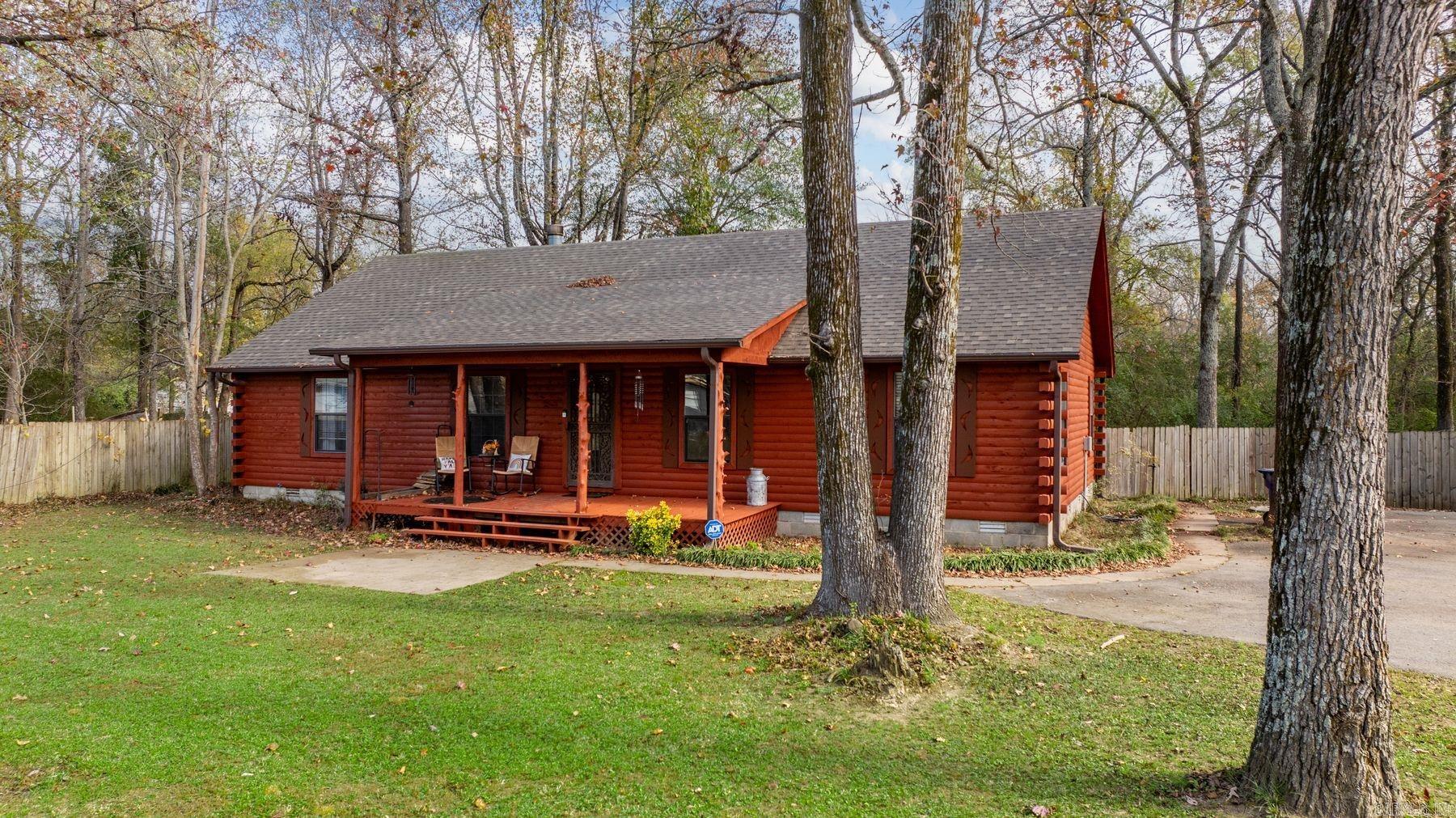 NEW Roof September 2024! Newly stained and sealed exterior on this cozy log cabin! Peaceful Oasis in the City! Log Home on over an acre sits off the road for maximum privacy. Large Vaulted Open Plan Living/Dining w Huge Rock Fireplace for Cozy Evenings. Gorgeous Wood Ceiling, Stainless Appliances updated in 2020. Gas stove. Big Island w Pot Rack overhead. Oversized Laundry. Master w Custom Vanity. Back Porch for relaxing and enjoying time with friends and family.  12x20 Shop w Electricity. Green Space behind. Country in the Heart of Cabot.