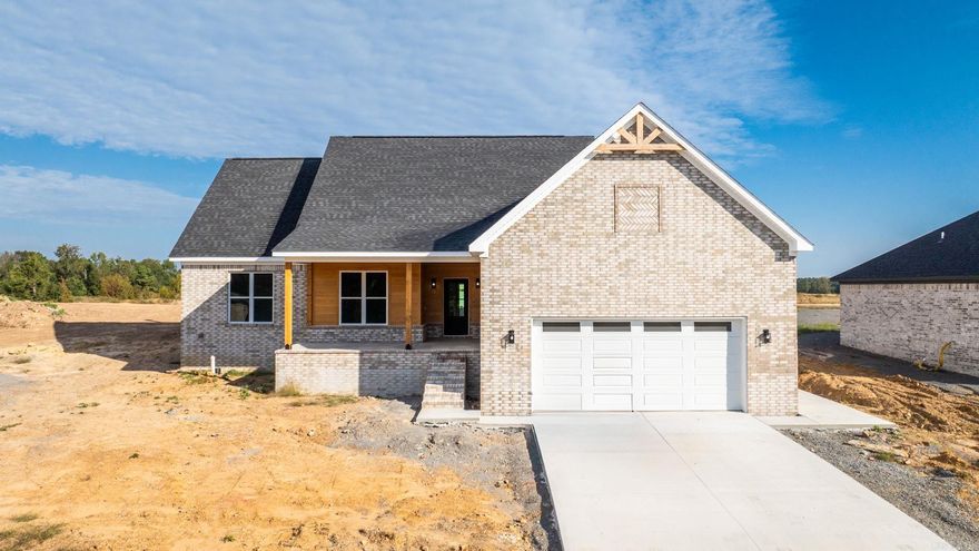 Stunning 4-bedroom, 2-bath home with new lake to be built in back, new neighborhood! Just steps from the city park with ballfields and a pool, this 1,954 sq. ft. home blends modern style with timeless craftsmanship. Inside, enjoy luxury vinyl plank flooring, vaulted ceilings, and an open-concept design anchored by a gas fireplace with custom shiplap. The chef’s kitchen features custom cabinetry, a large island, pantry, stainless appliances, and bold black fixtures. The primary suite is a retreat with dual vanities, a custom-tiled shower, and standalone soaking tub with tile surround. The secondary bath also shines with sleek tile and finishes. Outdoor living is at its best with spacious front and back porches, Cypress siding, and tongue-and-groove ceilings—all overlooking the lake and adjoining lot. A large garage with side door provides added convenience and storage.