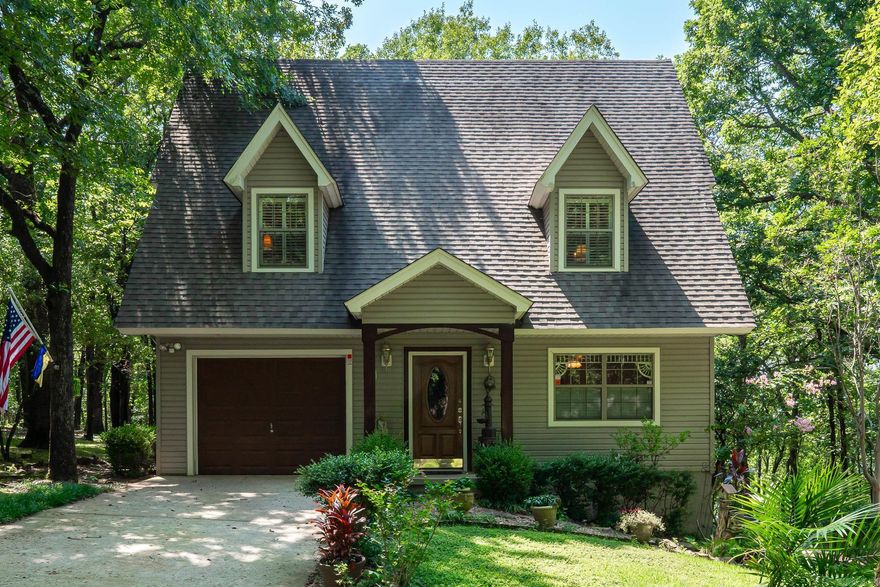 This special Petit Jean Mountain property is a once in a lifetime property! The 3 level custom built mountain top home is nestled into a tree covered 1.63 acres surrounded by Petit Jean State Park featuring: 3 beds/2 1/2 baths, formal dining room, sitting area, breakfast area, beautiful kitchen w/ island, & a huge living area w/tall ceilings fireplace, beautiful natural light, & an amazing view! The entire house has custom details throughout, beautiful trim, hardwood flooring, bead board, custom stair railing, ceiling beams & vaulted ceiling. Immaculately maintained. One owner home. The garage is heated and cooled and there is also a large divided heated & cooled unfinished space on the bottom floor behind the garage with its own entry. There is a separate cabin: the downstairs has a bedroom/living space, kitchenette, & full bath. Sleeping loft upstairs w/2 beds. Beautiful wrap around porch w/wonderful view. Fall/winter view of the Arkansas River. There is a separate 12 x 18 cottage style shop w/loft & front porch. Extensive landscaping, pathways, sitting areas, fire pit, & so much more.